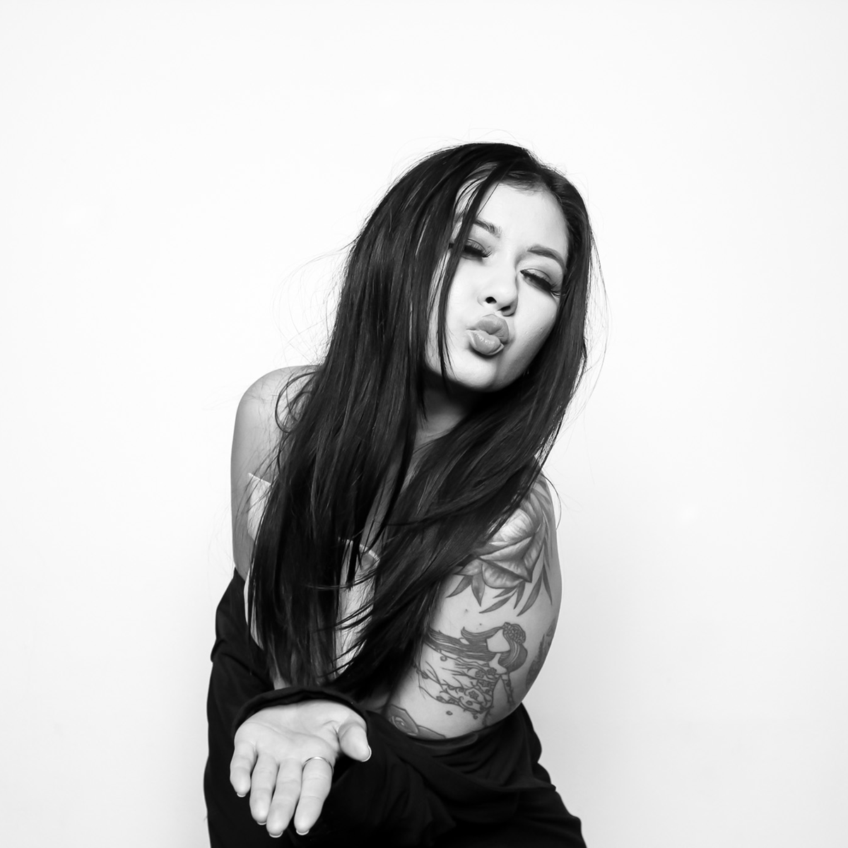 friends posing in front of photo booth capturing their photo with black and white glam filter