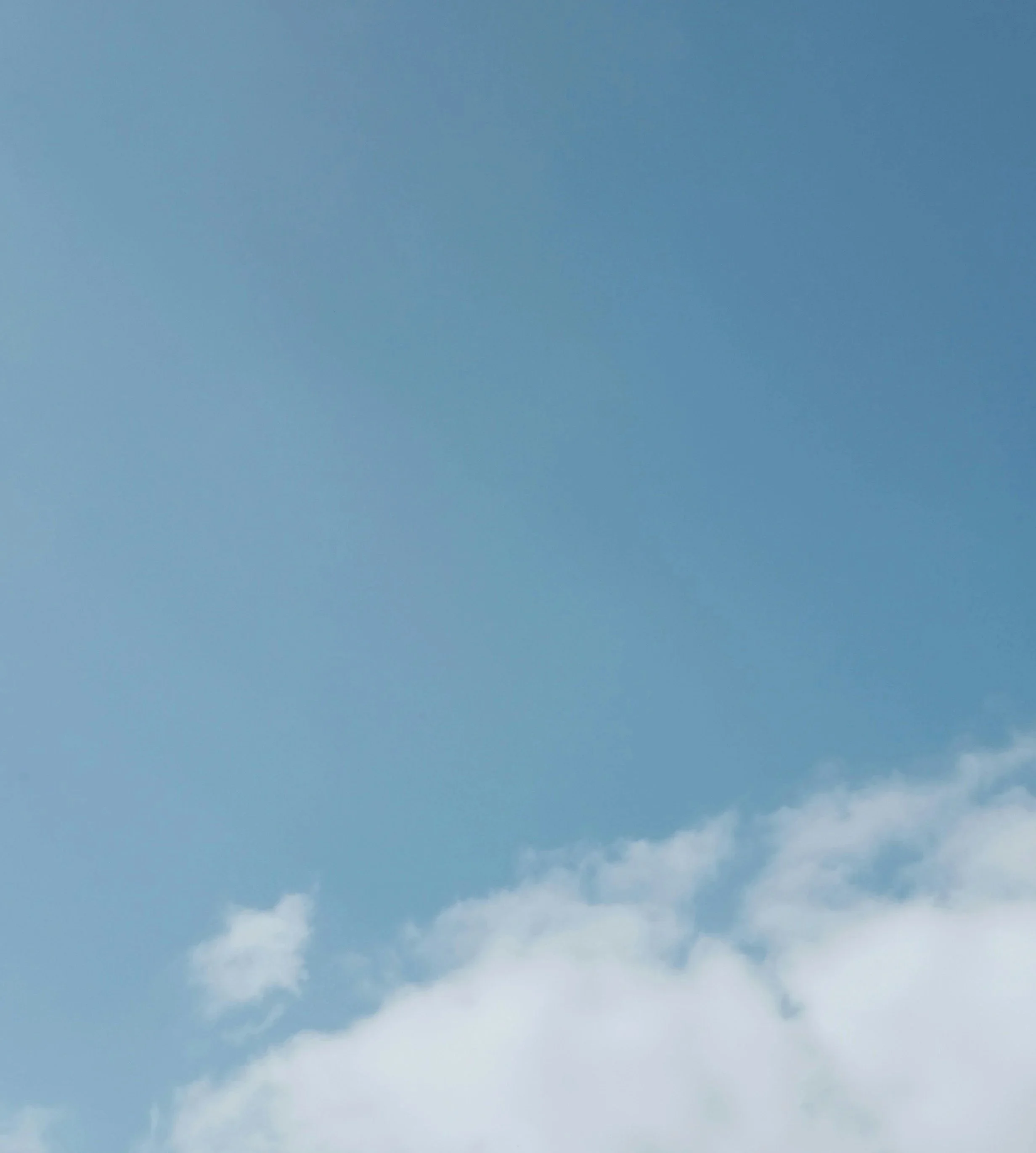 Close-up of a white building corner against a clear blue sky.