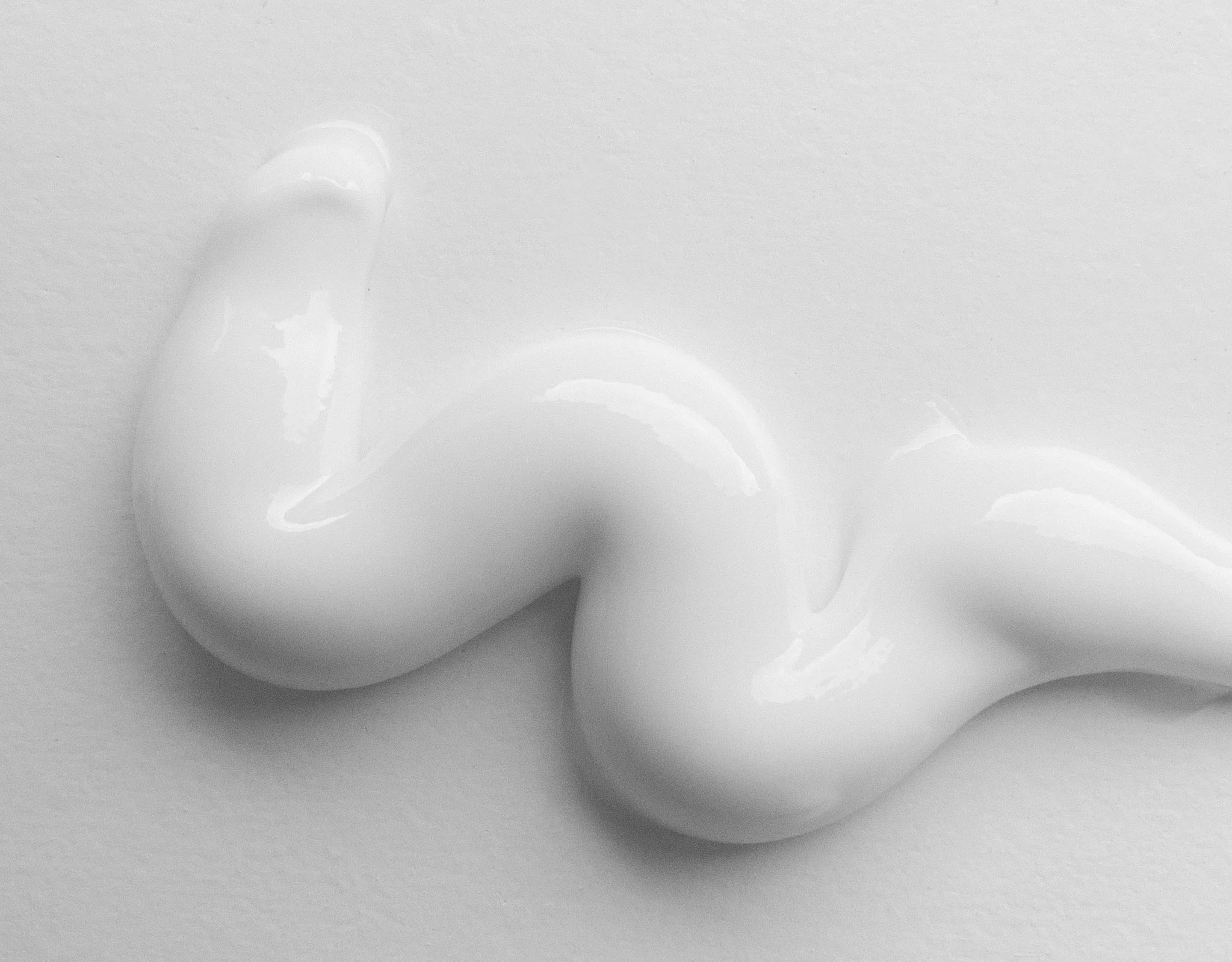 Close-up of white toothpaste on a flat surface.
