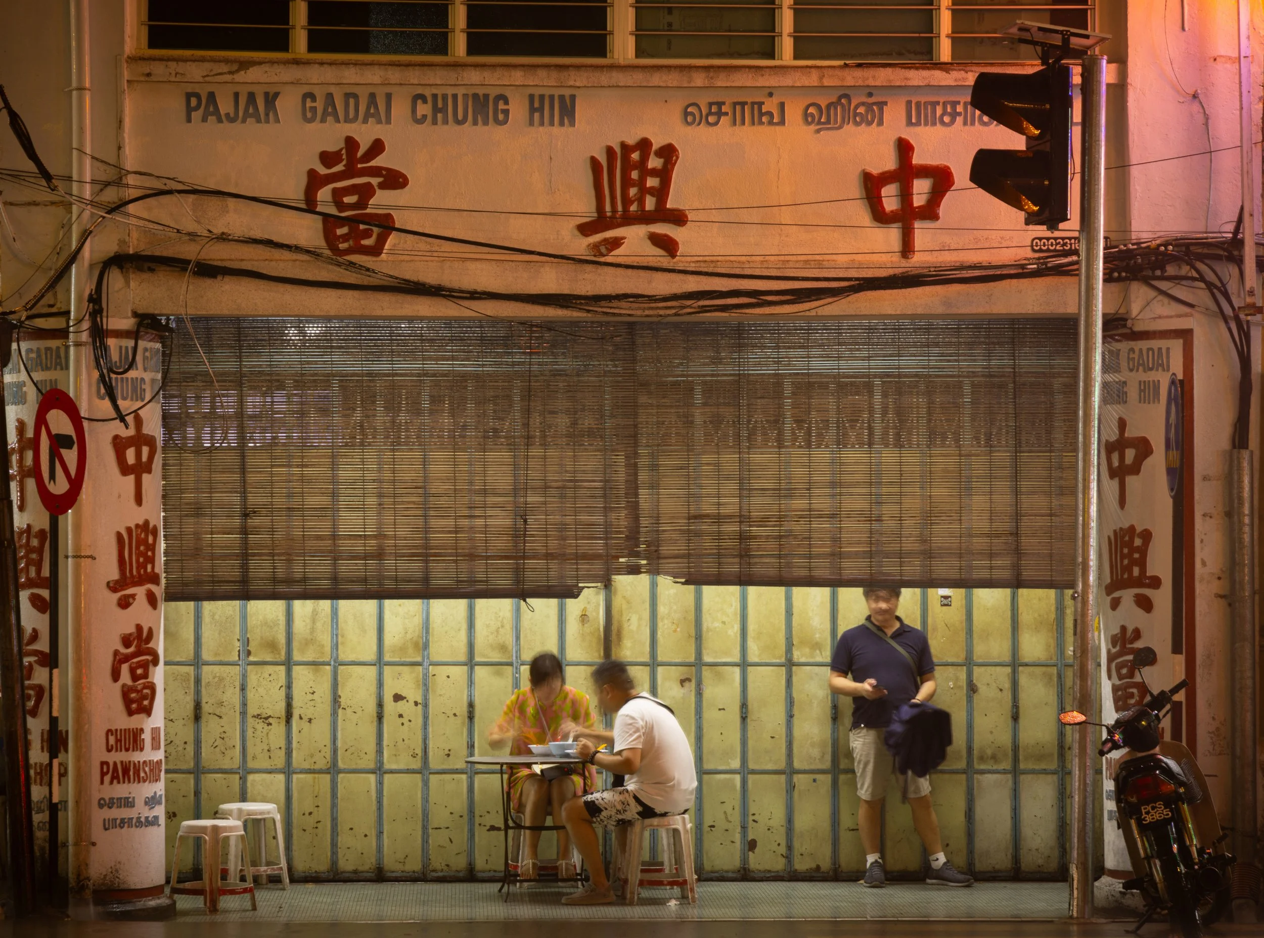 Eating from a hawker stand, Chulia St.  George Town, Penang, Malaysia