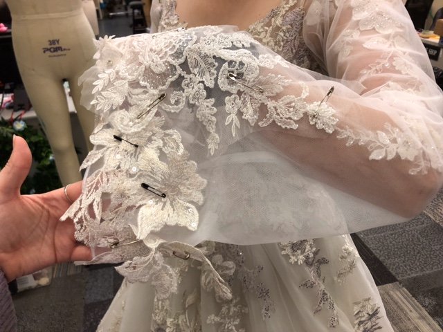 Under sleeves attached, excess mesh removed, cathedral sleeves basted on and appliques pinned for reference.