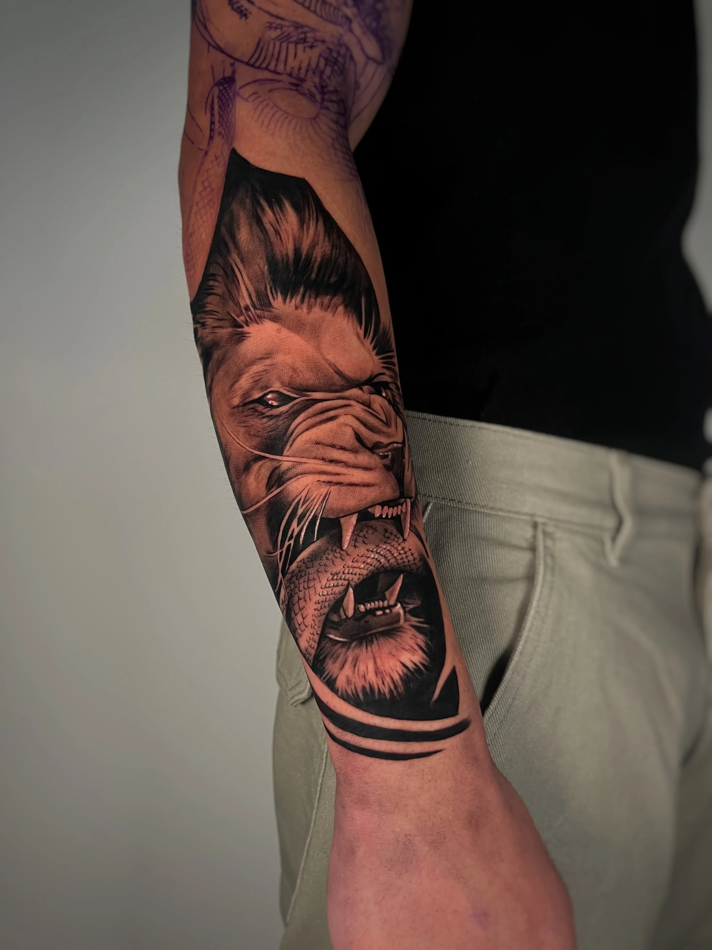 A realistic lion tattoo on a person's arm, featuring precise details and shading in shades of brown and black.