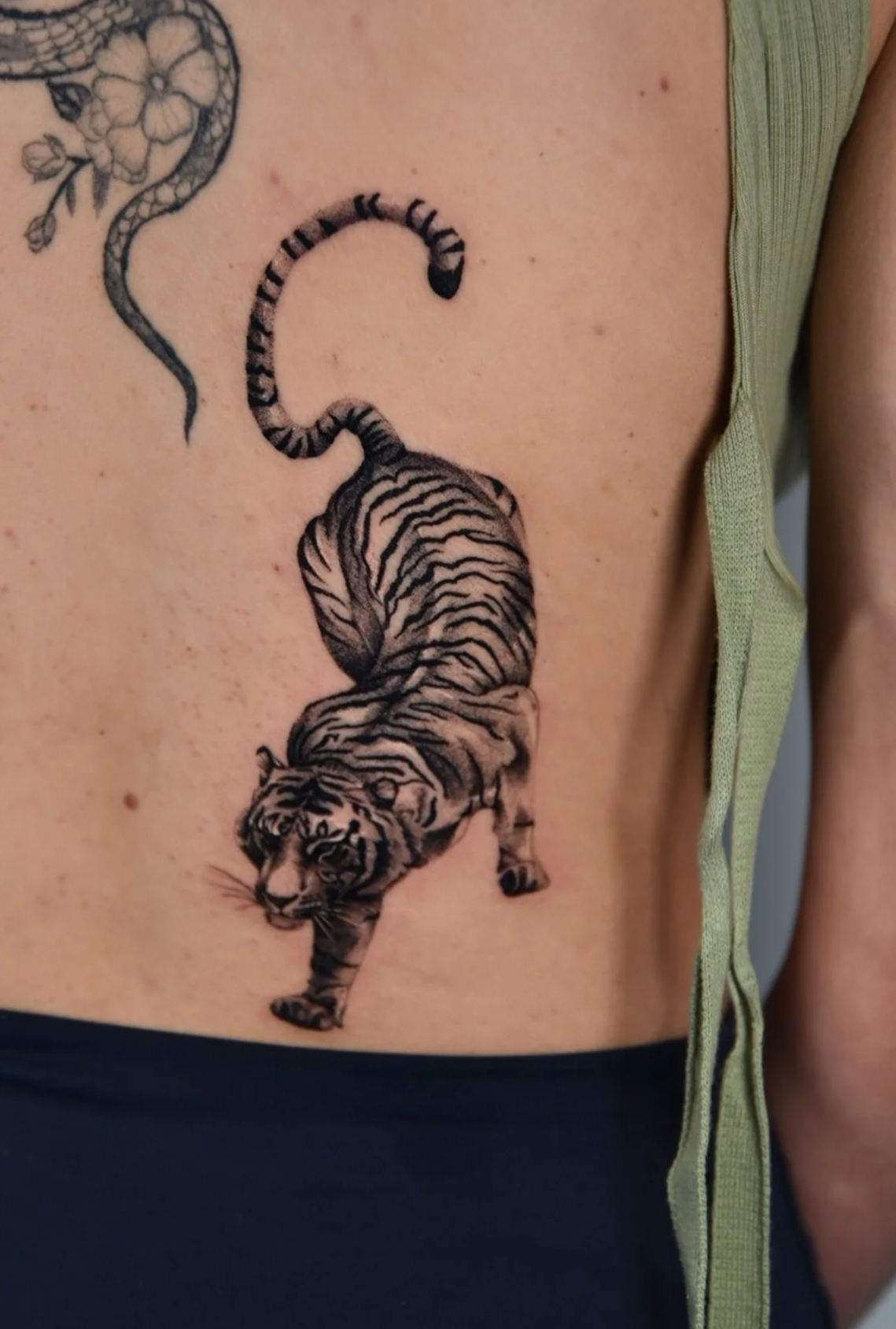 Tattoo of a black and white tiger on the side of the body.