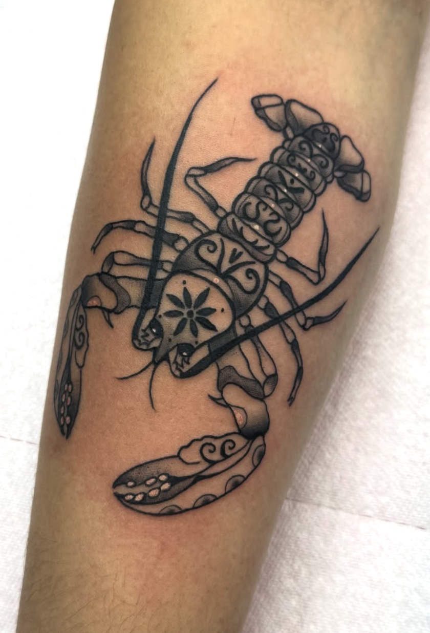 Online tattoo design featuring a scorpion's tail with decorative motifs, in black.