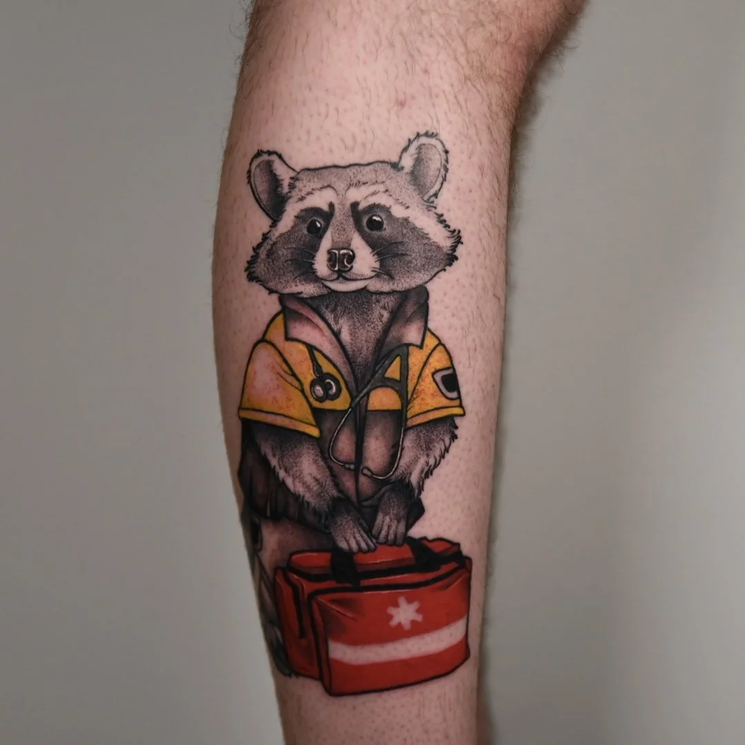 Tattoo of a rat wearing a lifeguard jacket with a first-aid kit.
