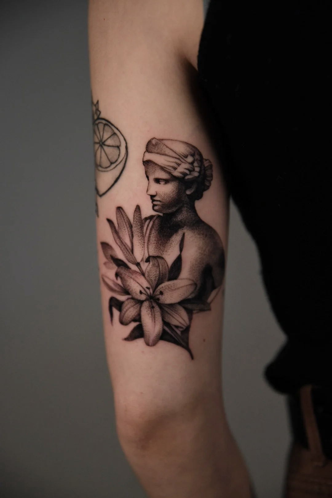 Tattoo of a woman with flowers on her arm
