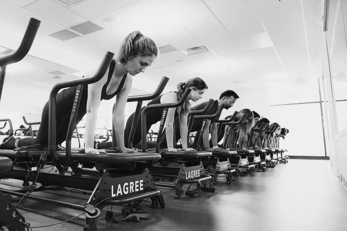 A group of people doing moves on Megaformer machine at FORM BY TWO in Princeton, New Jersey.