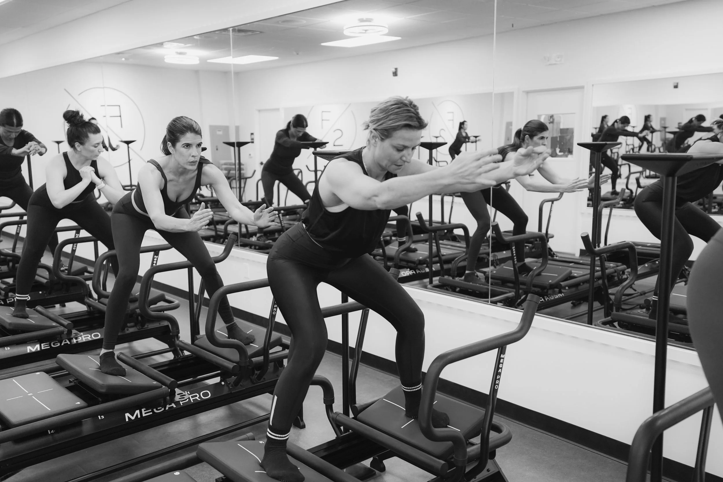 Group of women exercising on Megaformer machines at FORM BY TWO in Princeton, New Jersey.