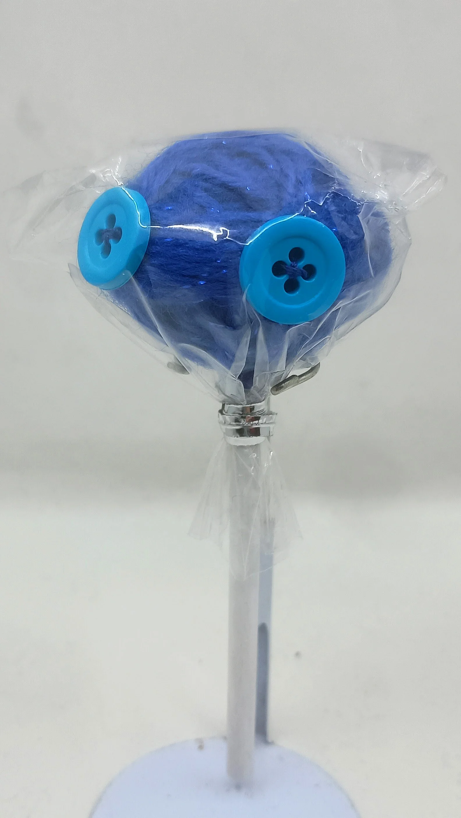 Lollipop Omni Doll, yarn, buttons, dowel, plastic bag, 2022