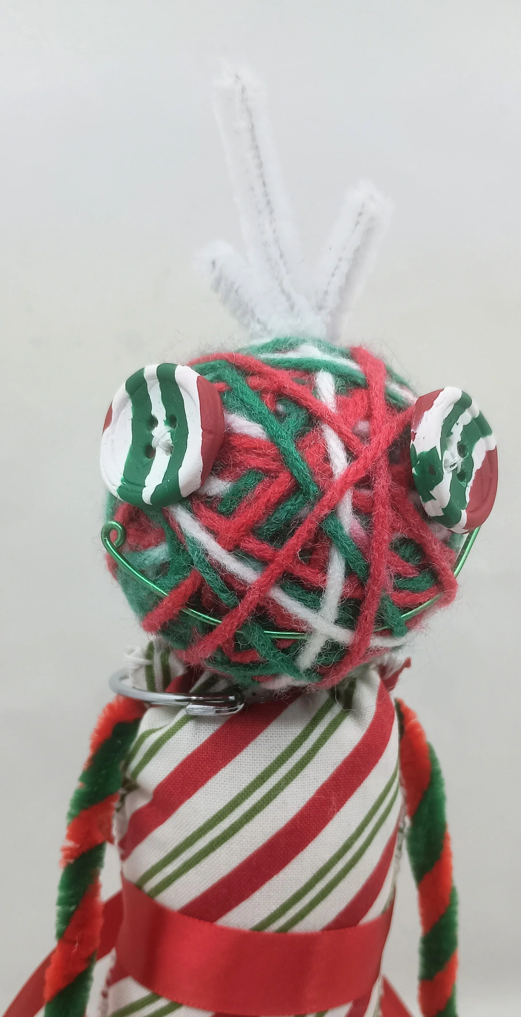 Candy Cane Omni Doll Detail, yarn, pipe cleaners, felt, polymer clay, 2024
