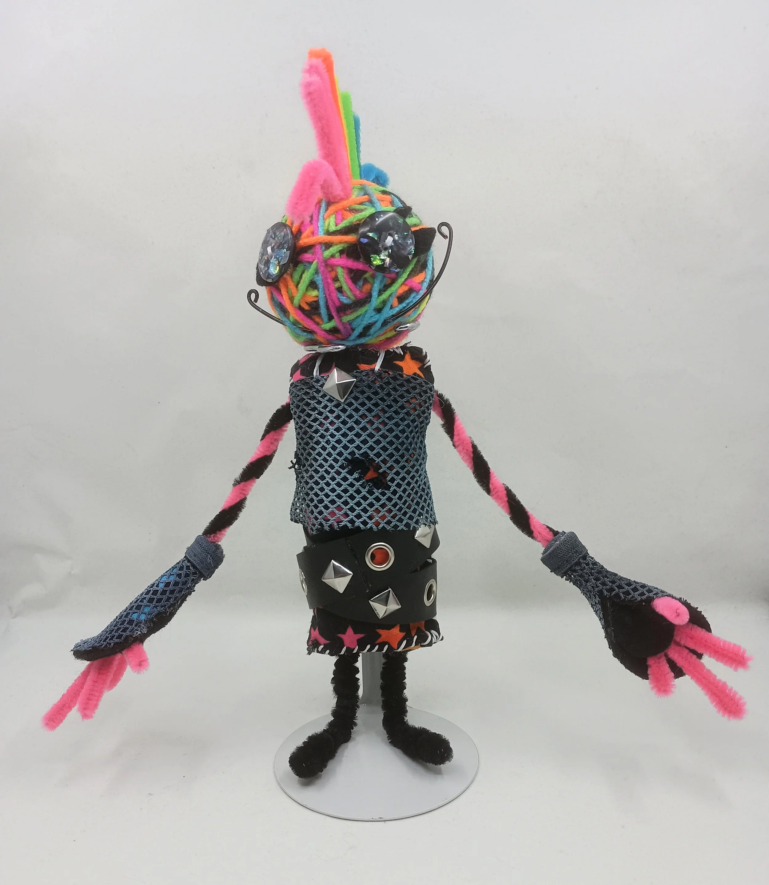 Glamrock Omni Doll, yarn, pipe cleaners, buttons, mesh, faux leather ribbon, 2025
