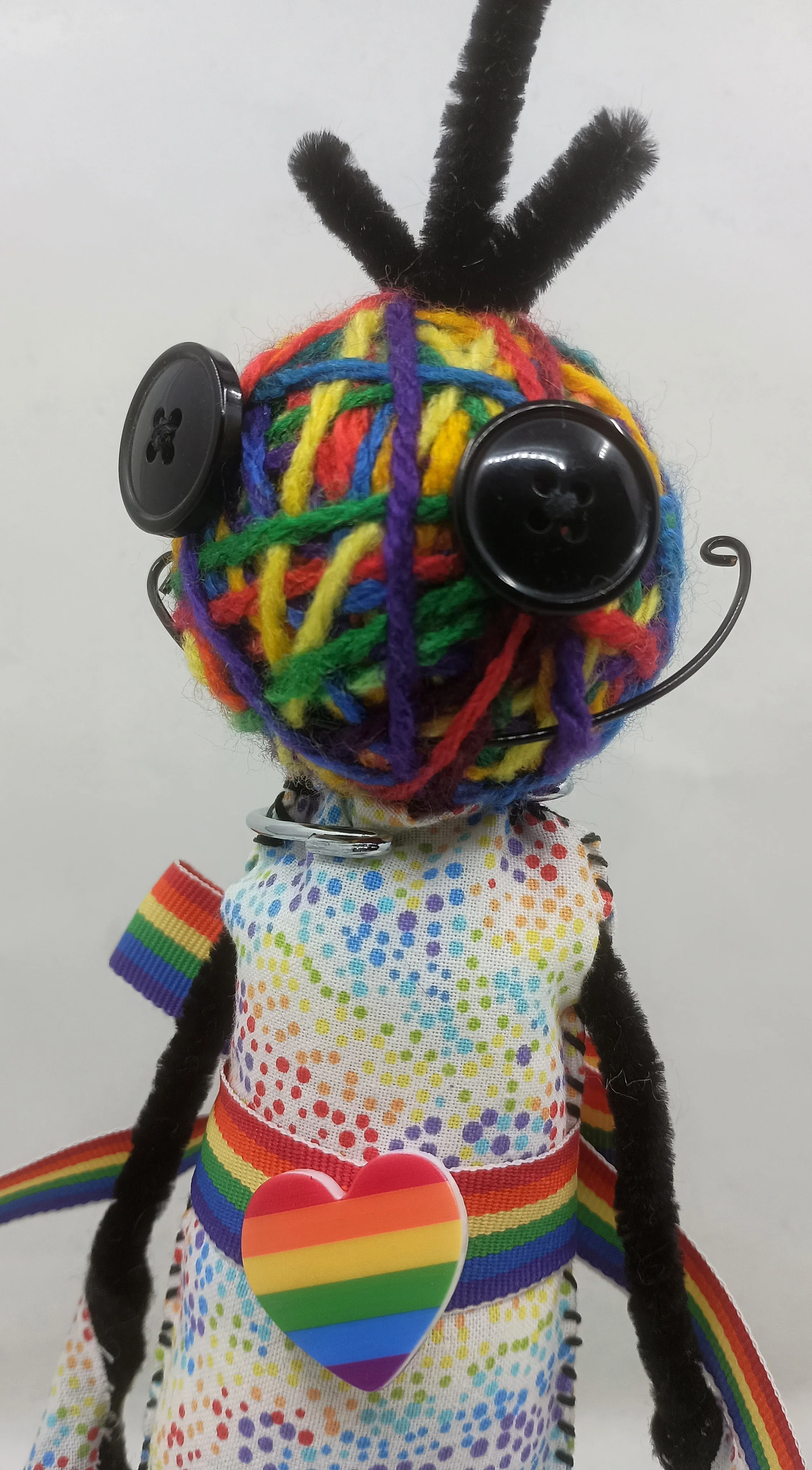 Rainbow Omni Doll Detail, yarn, pipe cleaners, felt, buttons, 2025