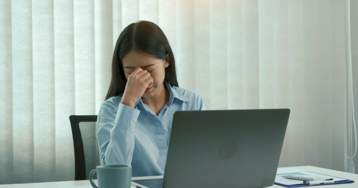 Woman at her desk stressed about her gut health