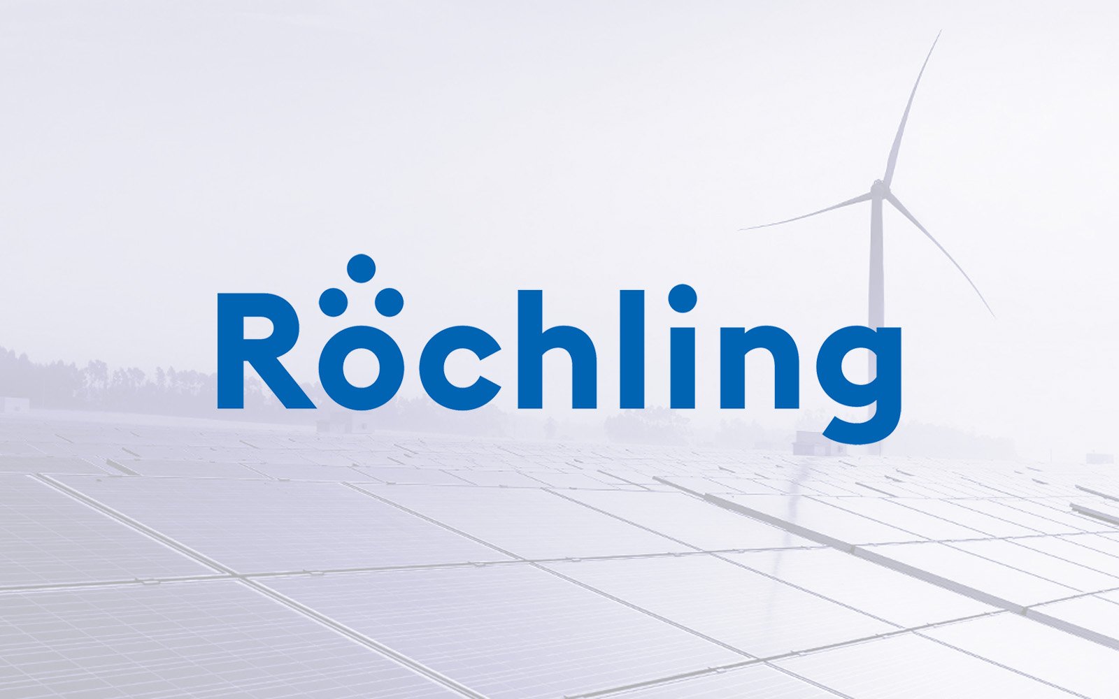 Röchling logo superimposed over a background of solar panels and a wind turbine in a foggy landscape.