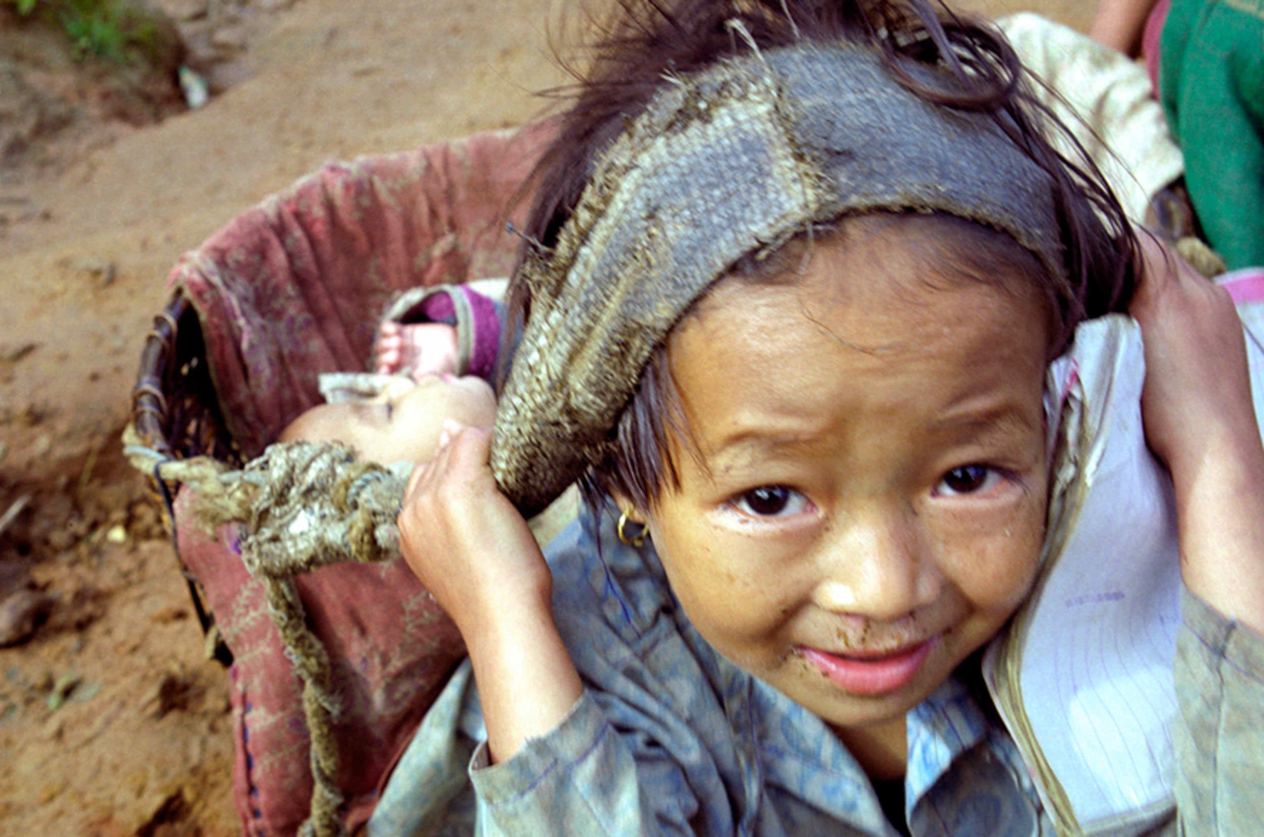 9/. Girl carries baby on back near Buldanda, Sulu-Khumbu (Everest region), Nepal. Photo by James Sturcke | Sturcke.org