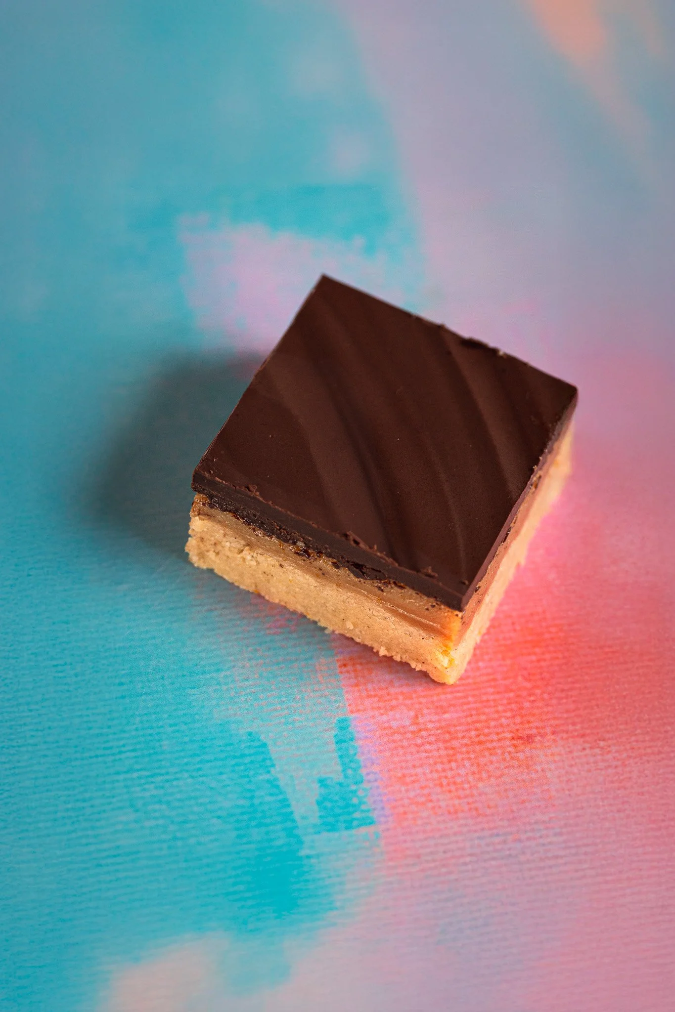 Chocolate and vanilla layered dessert on colorful background.