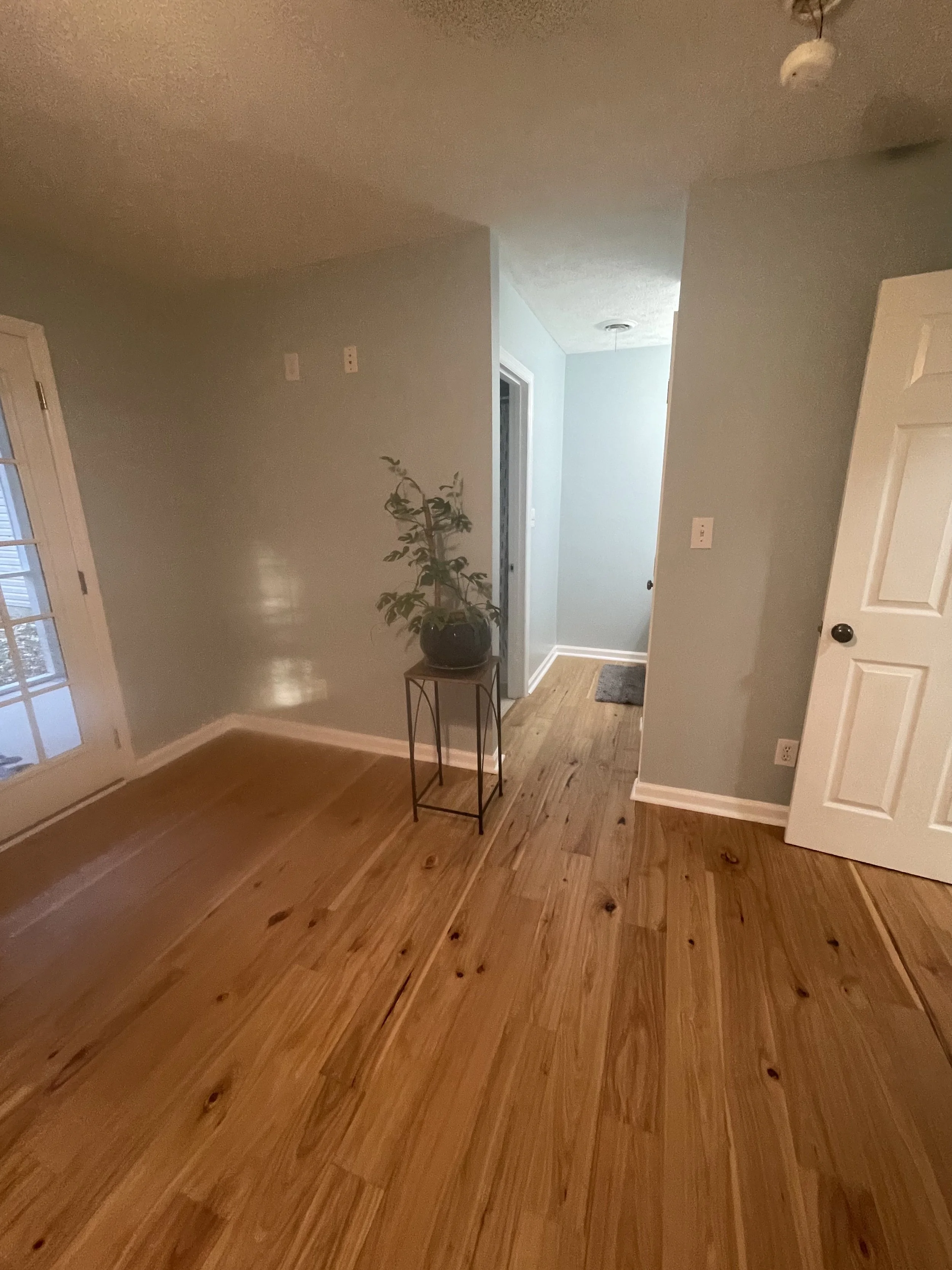 “Refinished hardwood flooring in Augusta residential living room by ProCoat Flooring Solutions”
