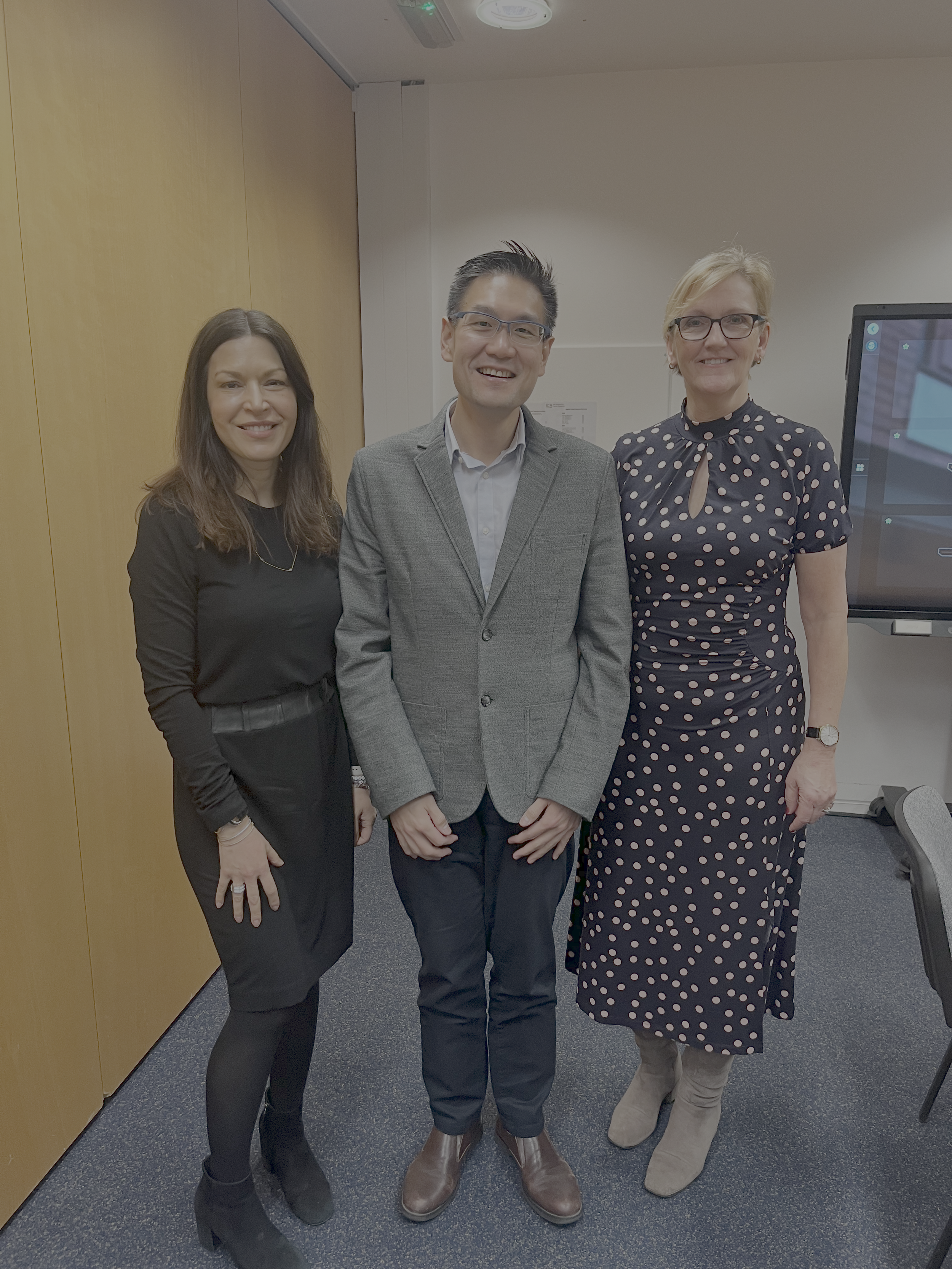 Photo showing three people smiling.  Photo shows OCR co-founders Yvonne Diaz and Jan Clark in professional dresses and the ICR's Prof Paul Huang - researcher.
