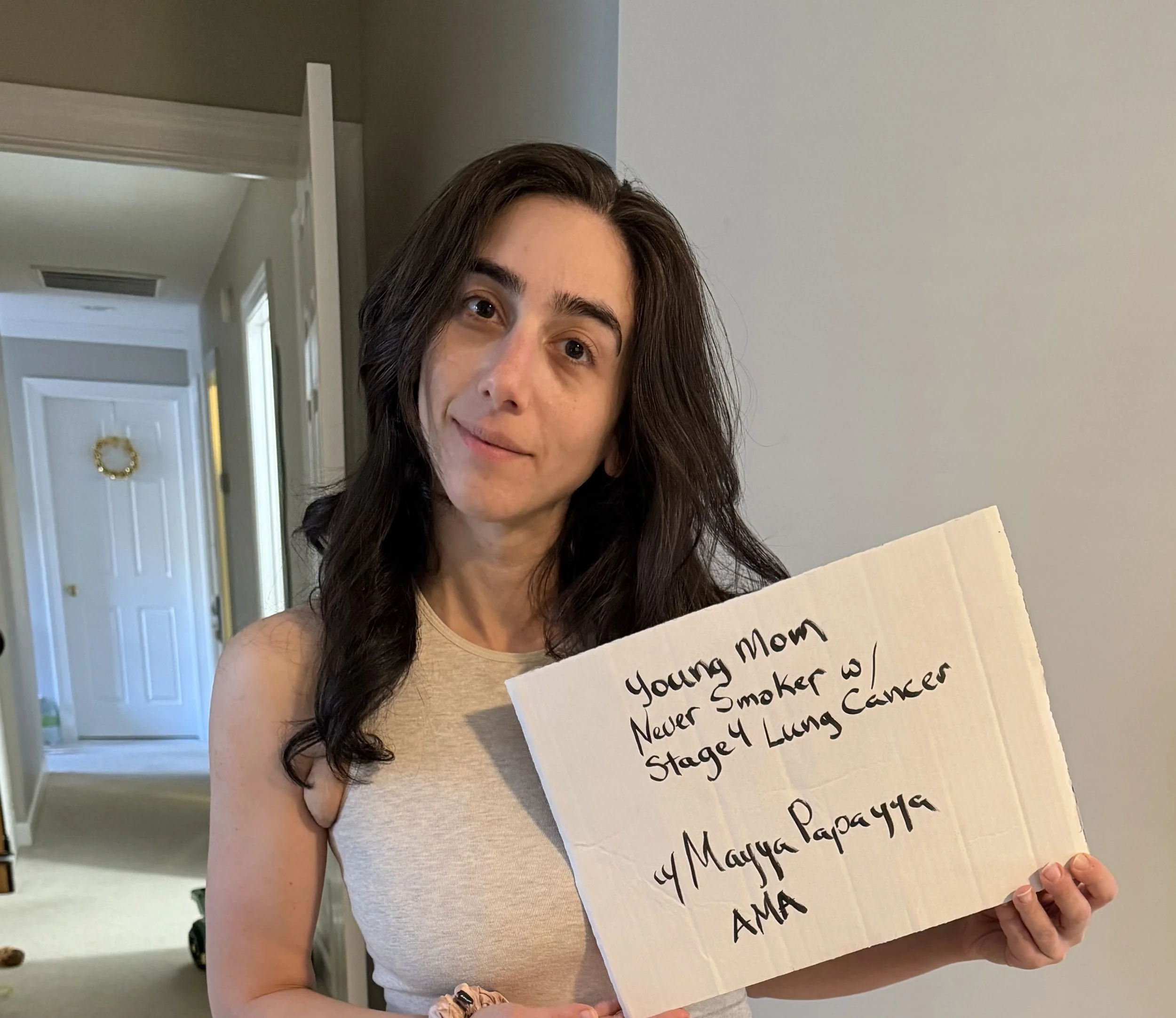 Mayya - looking young, fresh faced and holding up a sign with her name has decided to tackle advocacy to make a difference