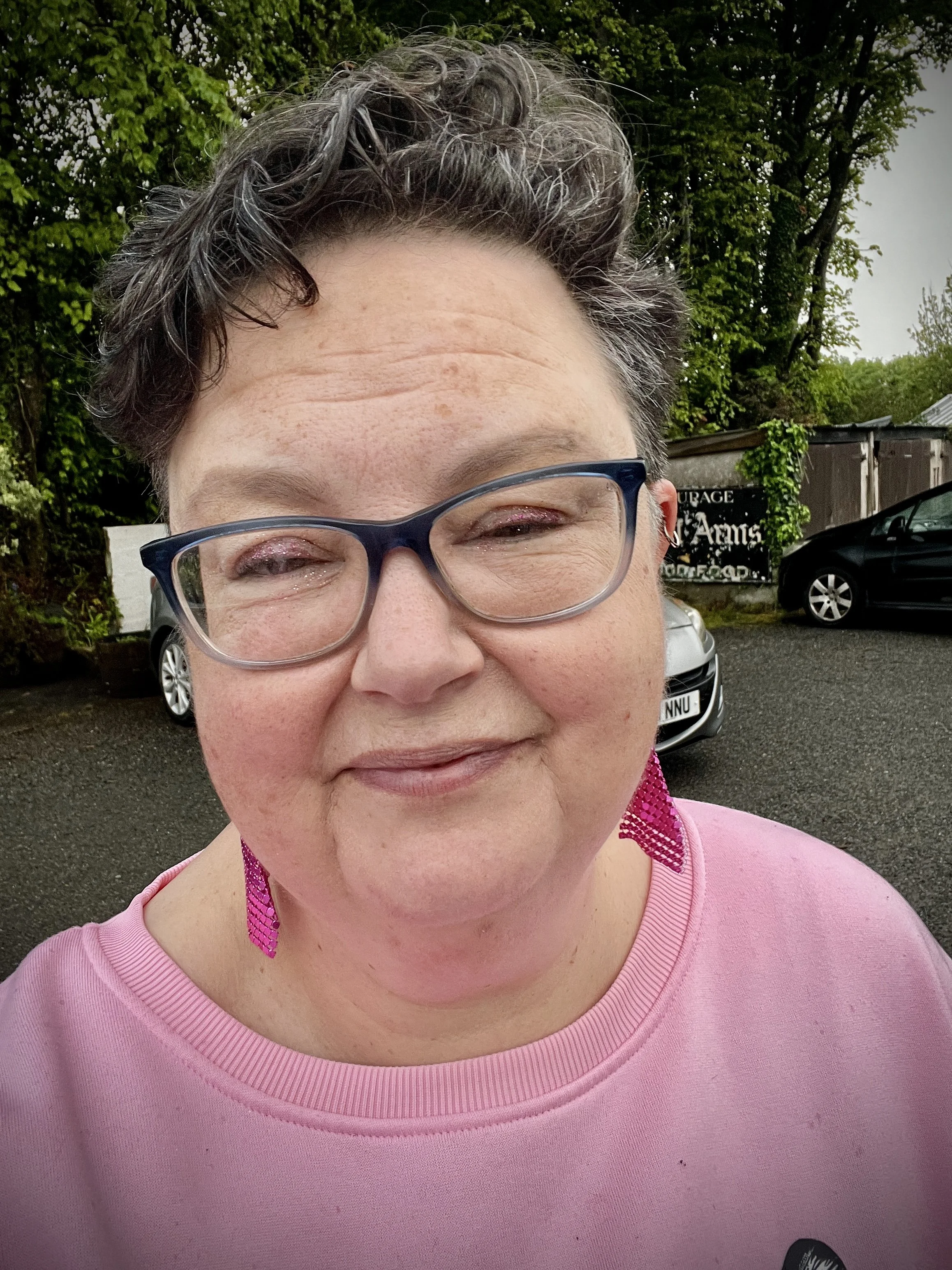 Allison, close up, she's been through a lot but smiling and wearing pink - her favourite colour.