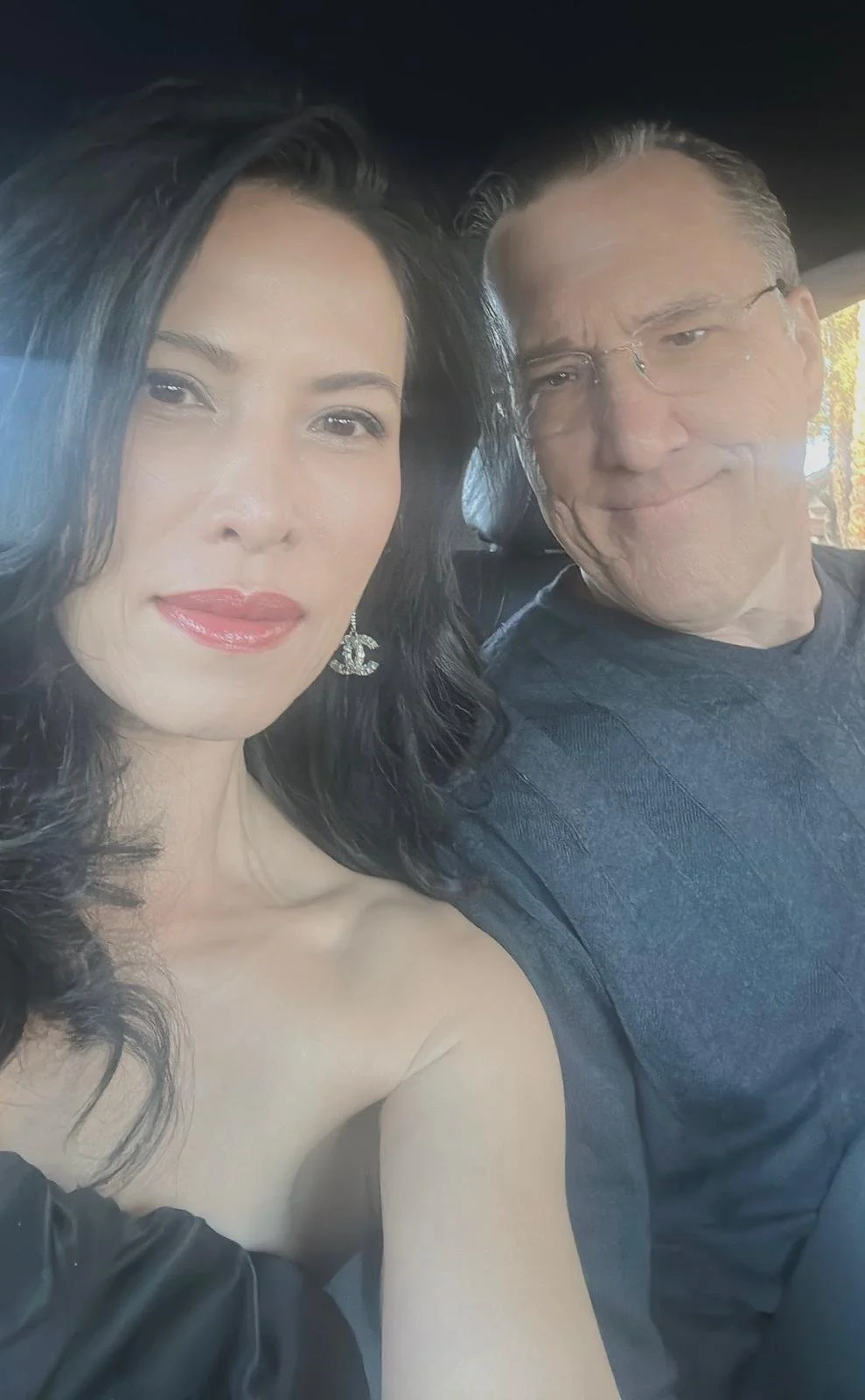 Kimberly and her husband smiling in a car.