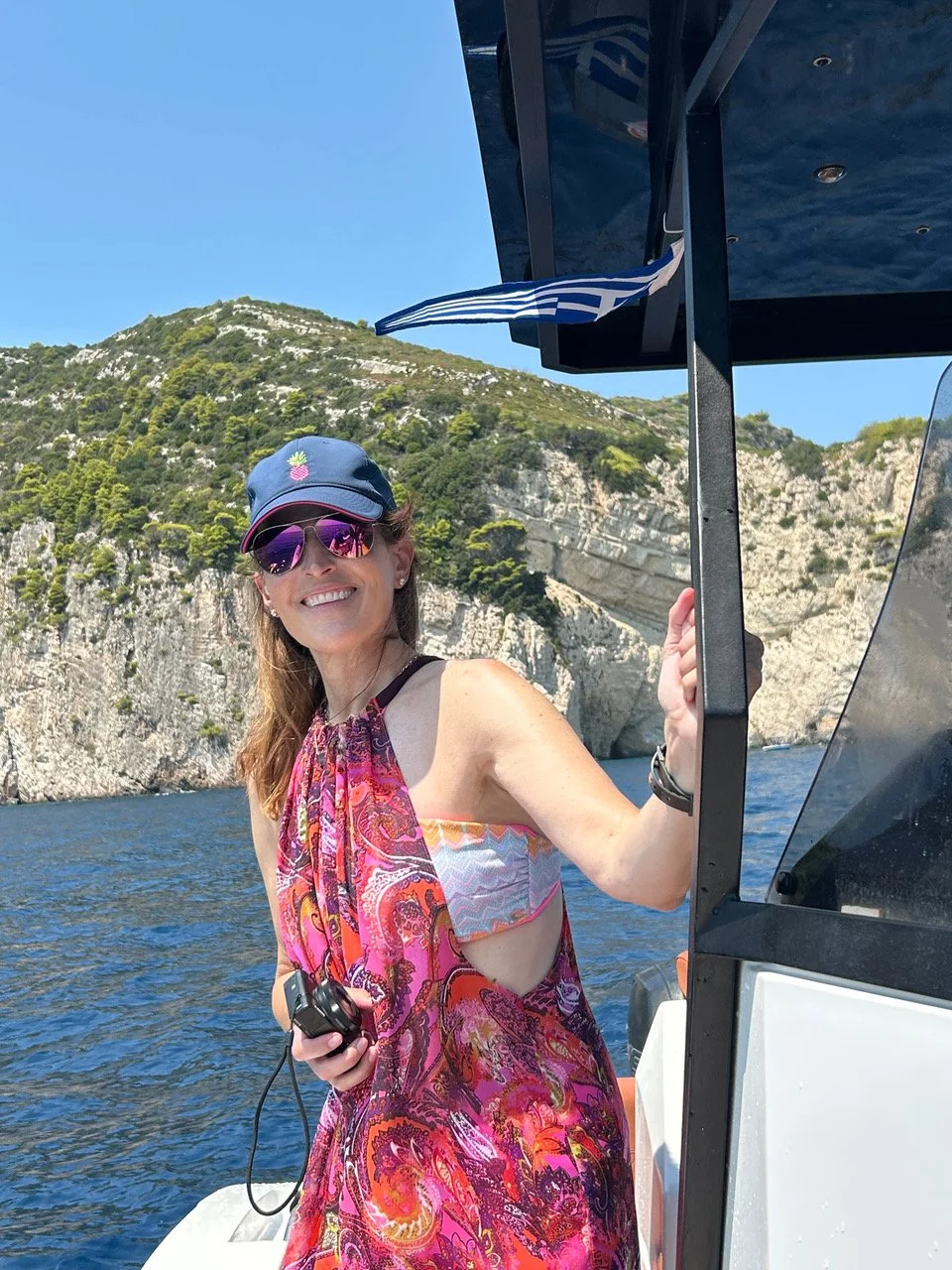 Photo of Rosee - living with stage 4 lung cancer. In a bathing suit, on a boat with a big blue sky, looking young and healthy