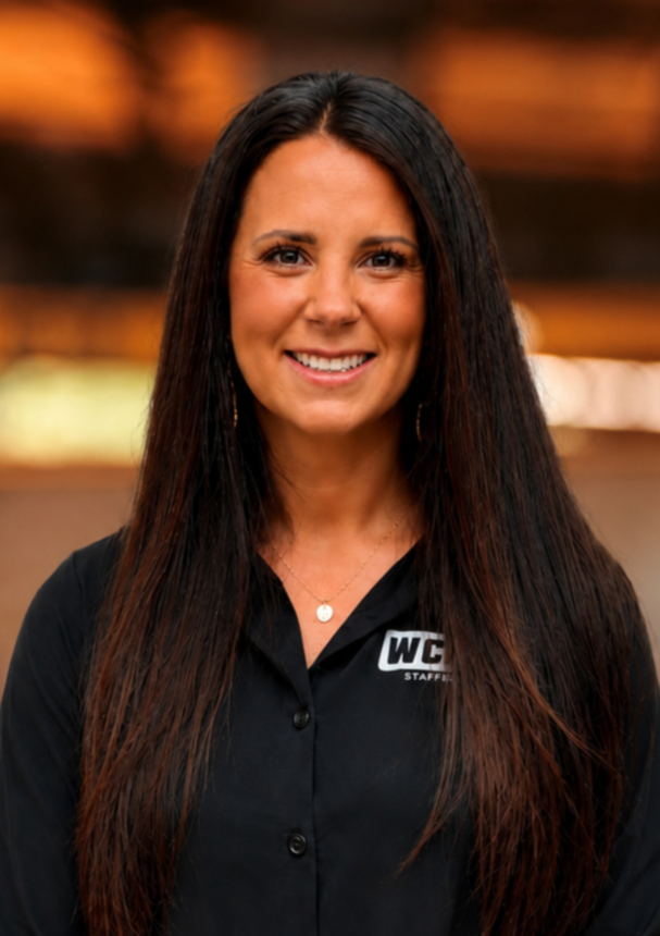 Kelsay Worth, CFO of Worth Stairs & Rails. A woman with long dark hair smiling indoors in a well-lit setting.