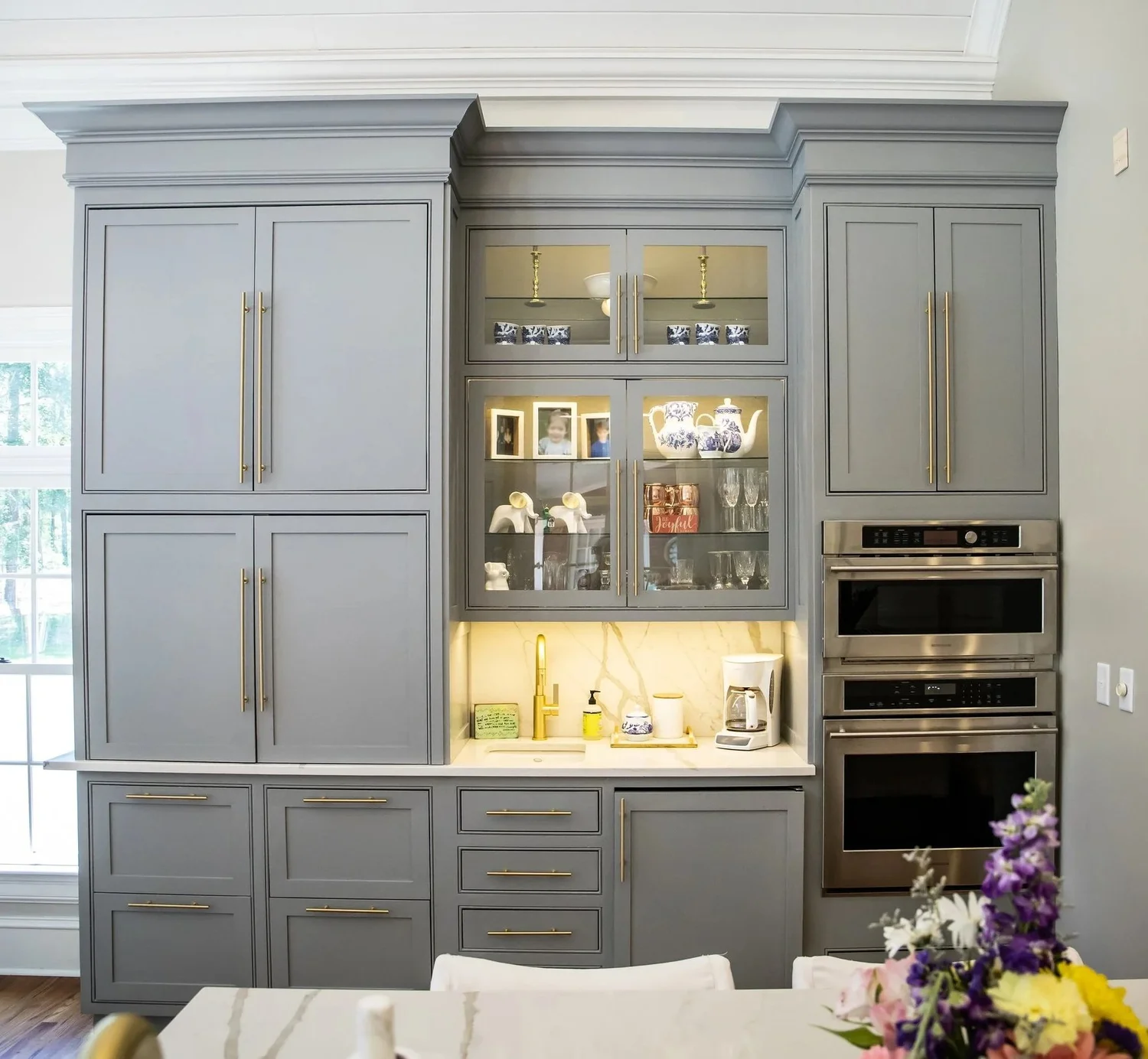 Grey cabinetry with a lit glass display