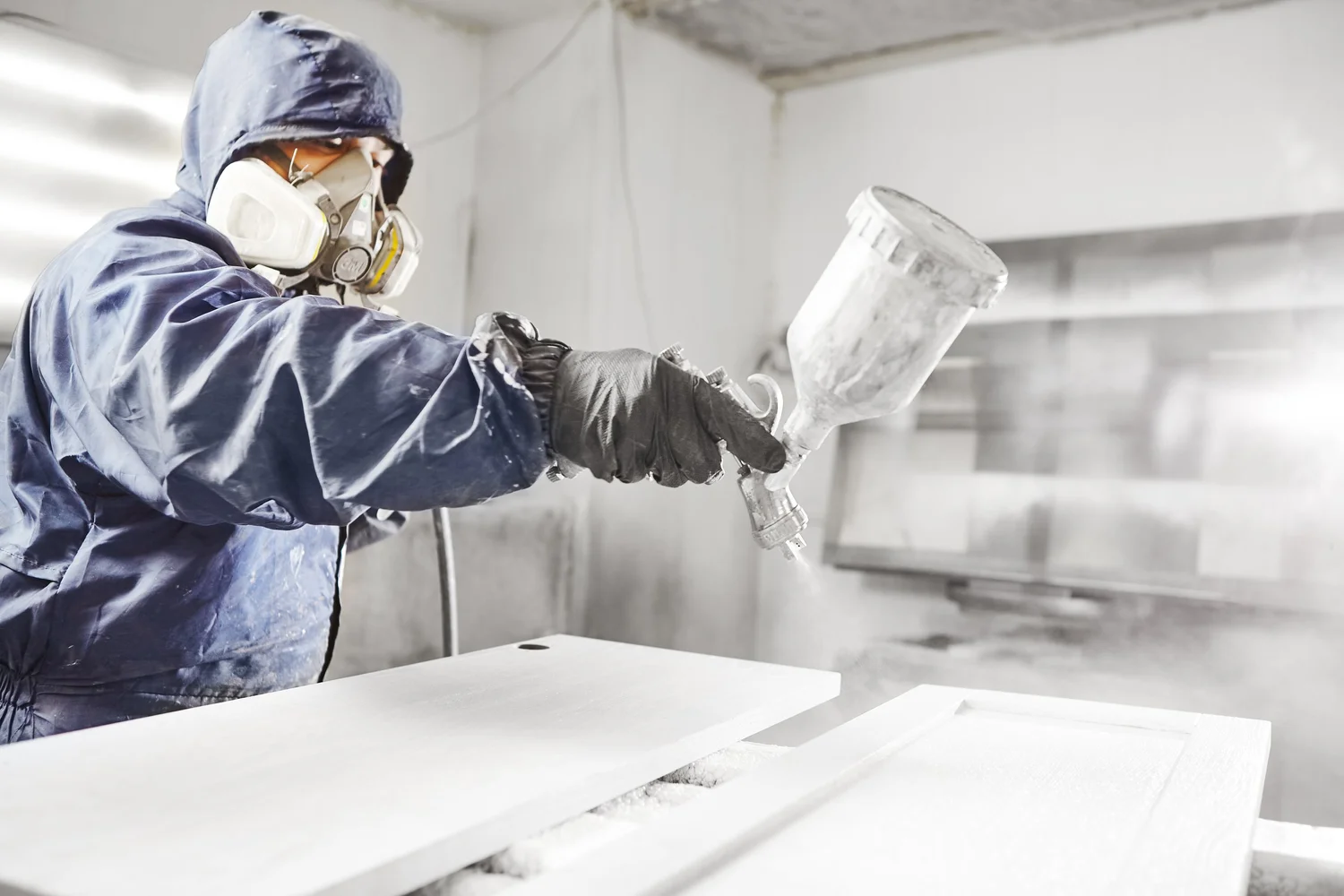 A cabinet door being spray finished