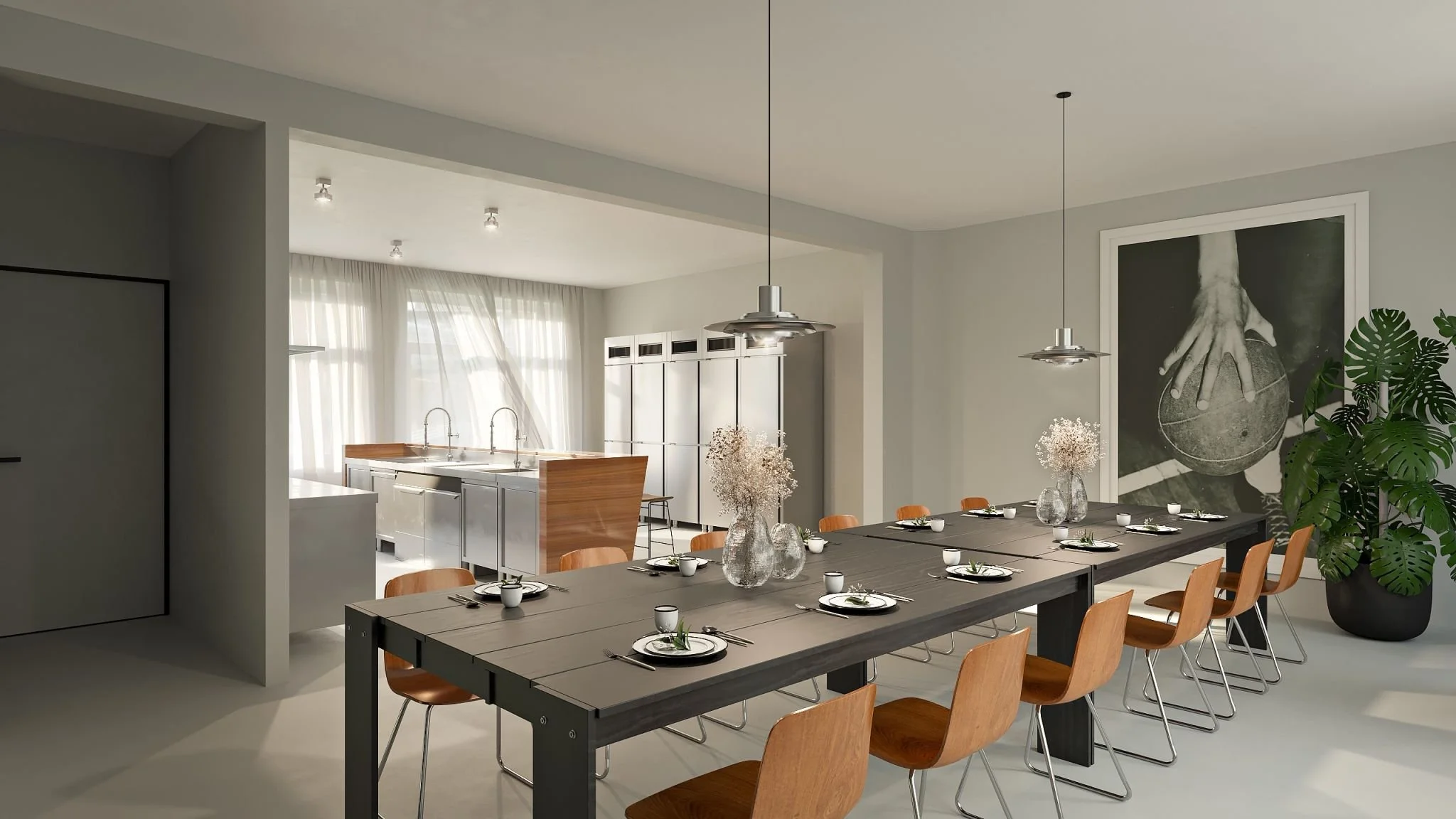 Modern dining room with a large table set with place settings, a large black and white artwork, a potted plant, and a kitchen area with white cabinetry and a window with sheer curtains.