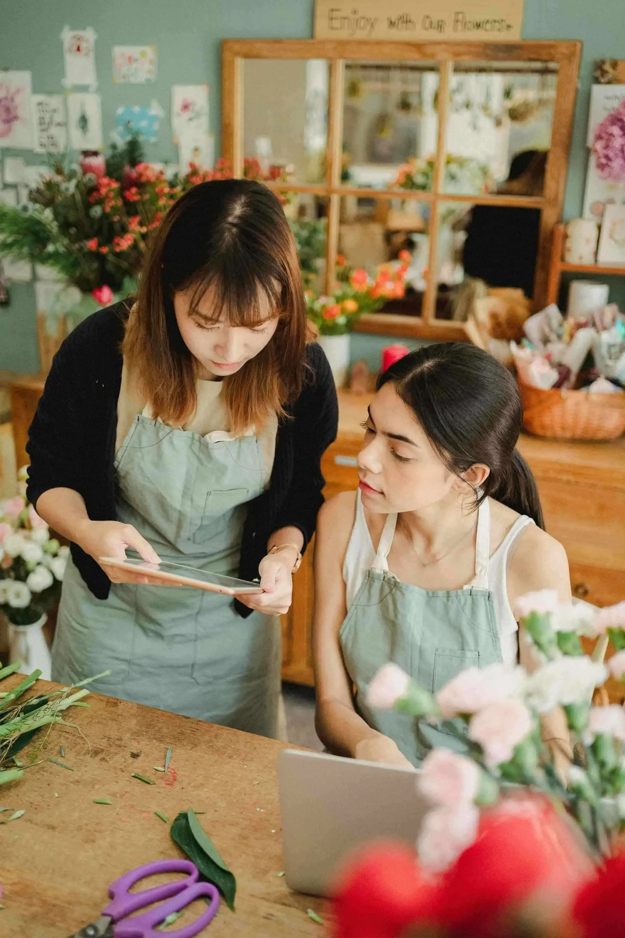 Two small business owners reviewing their marketing plan on a tablet