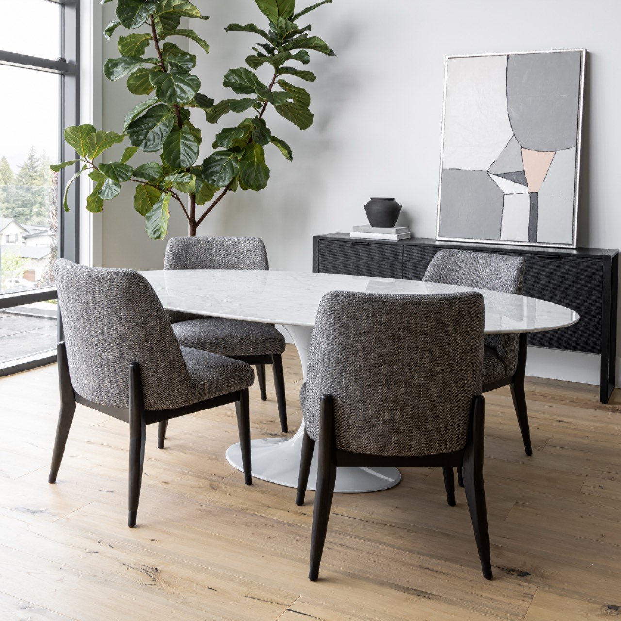 Dining Tables category image featuring a modern wood or marble dining table styled in a quiet-luxury West Coast dining space, part of Furniture 28’s curated collection.