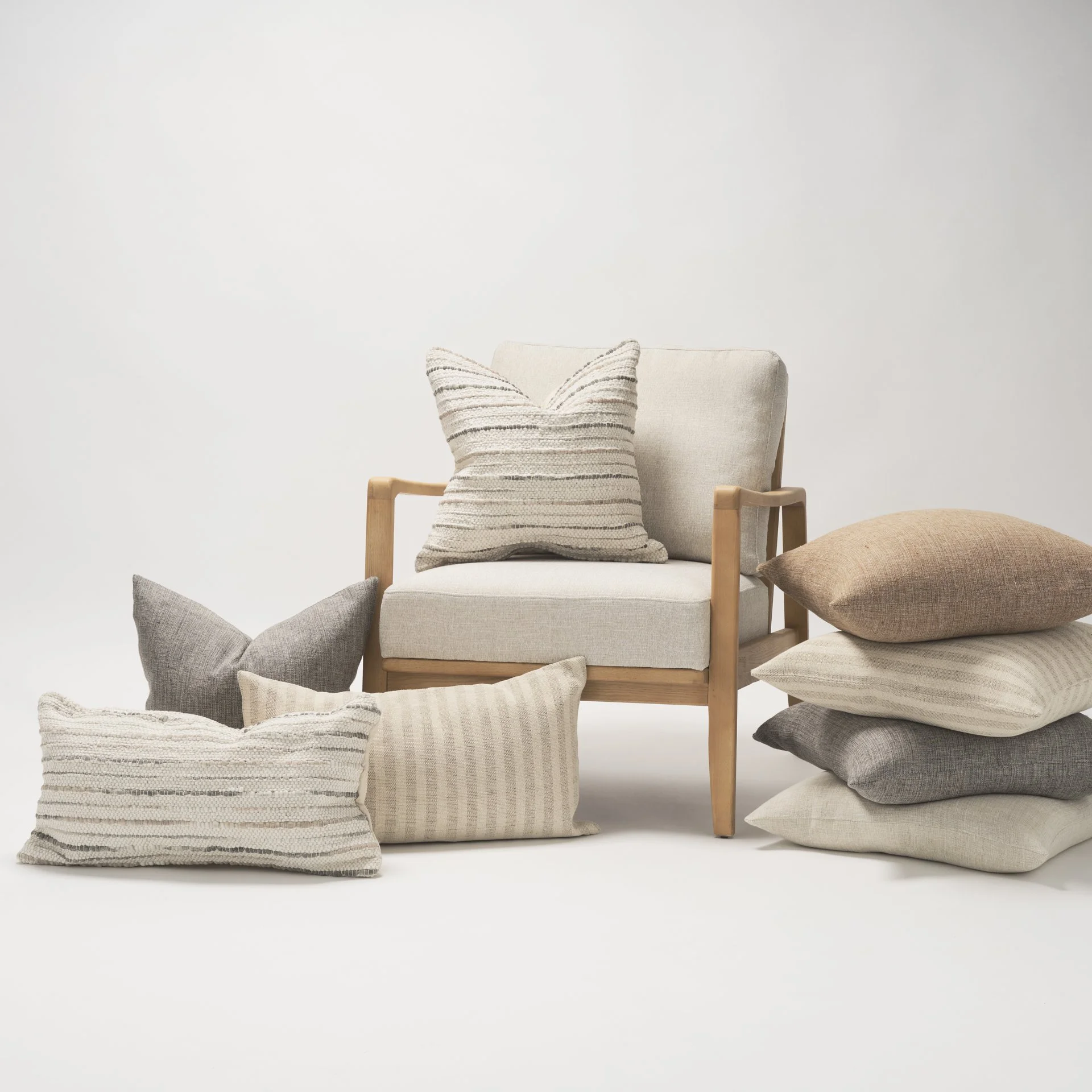 warm neutral pillows in a pile.