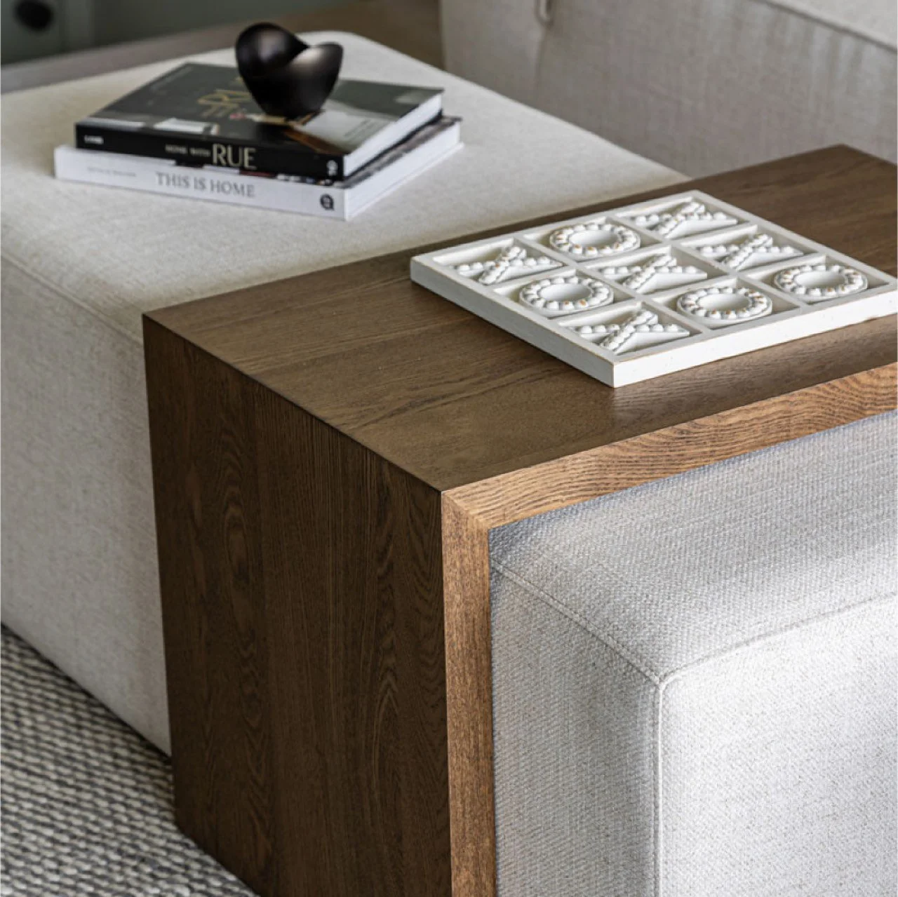 Bench-ottoman-uphostlered-cream-fabric-with--dark-wood-waterfall-table-staged-decor.jpg