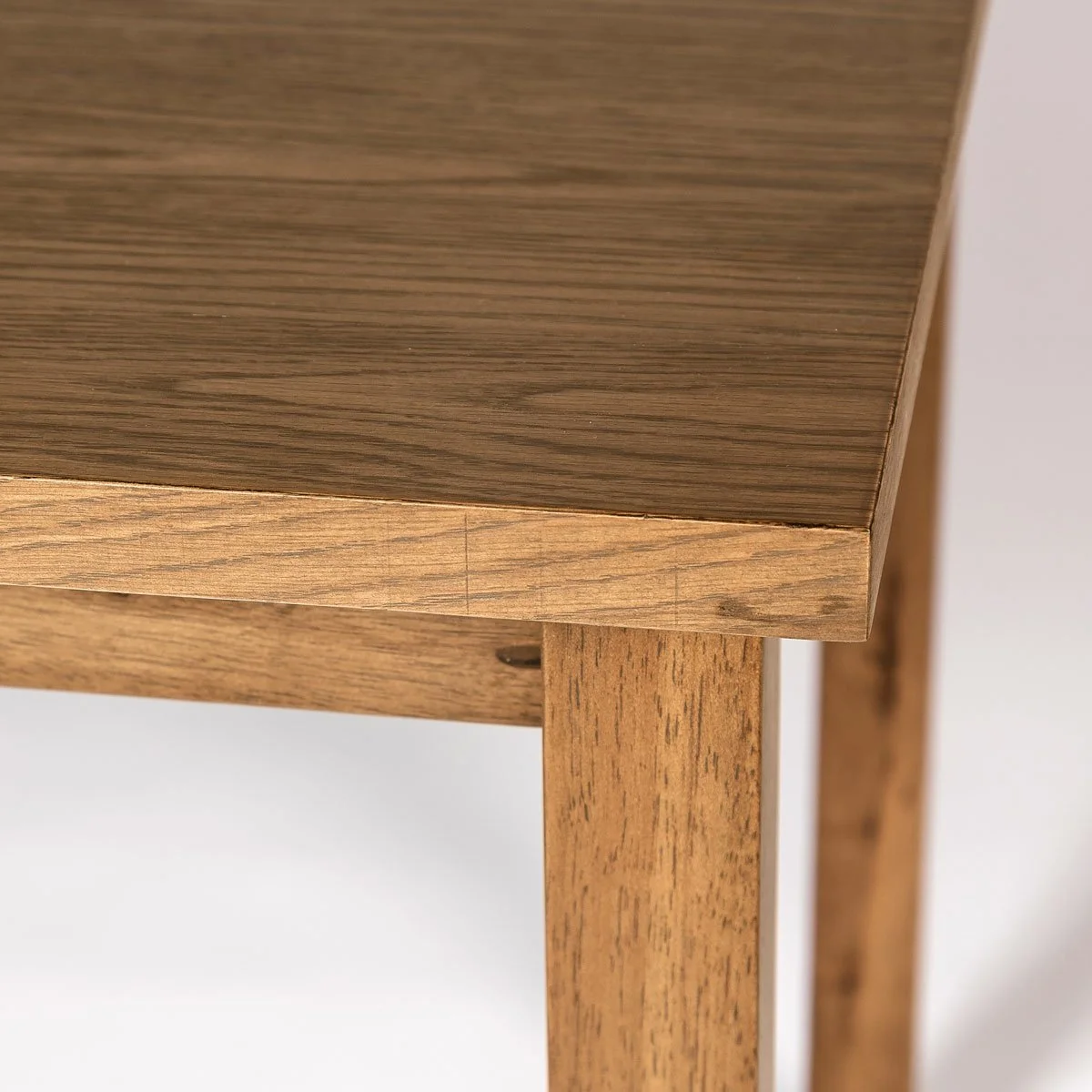 14 extension dining table in smoked chestnut corner detail .jpg