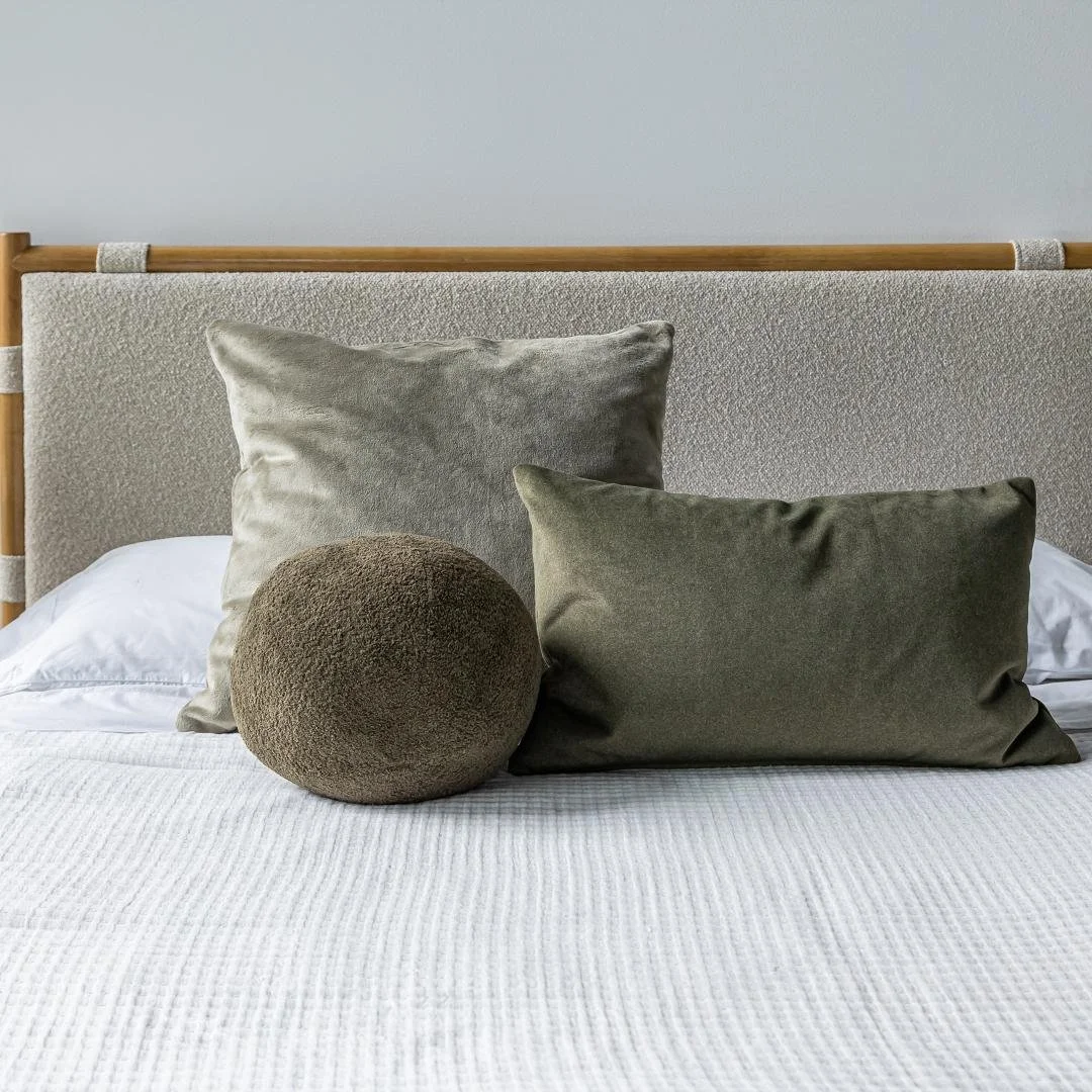 Sculptural dark green throw pillow for modern interiors