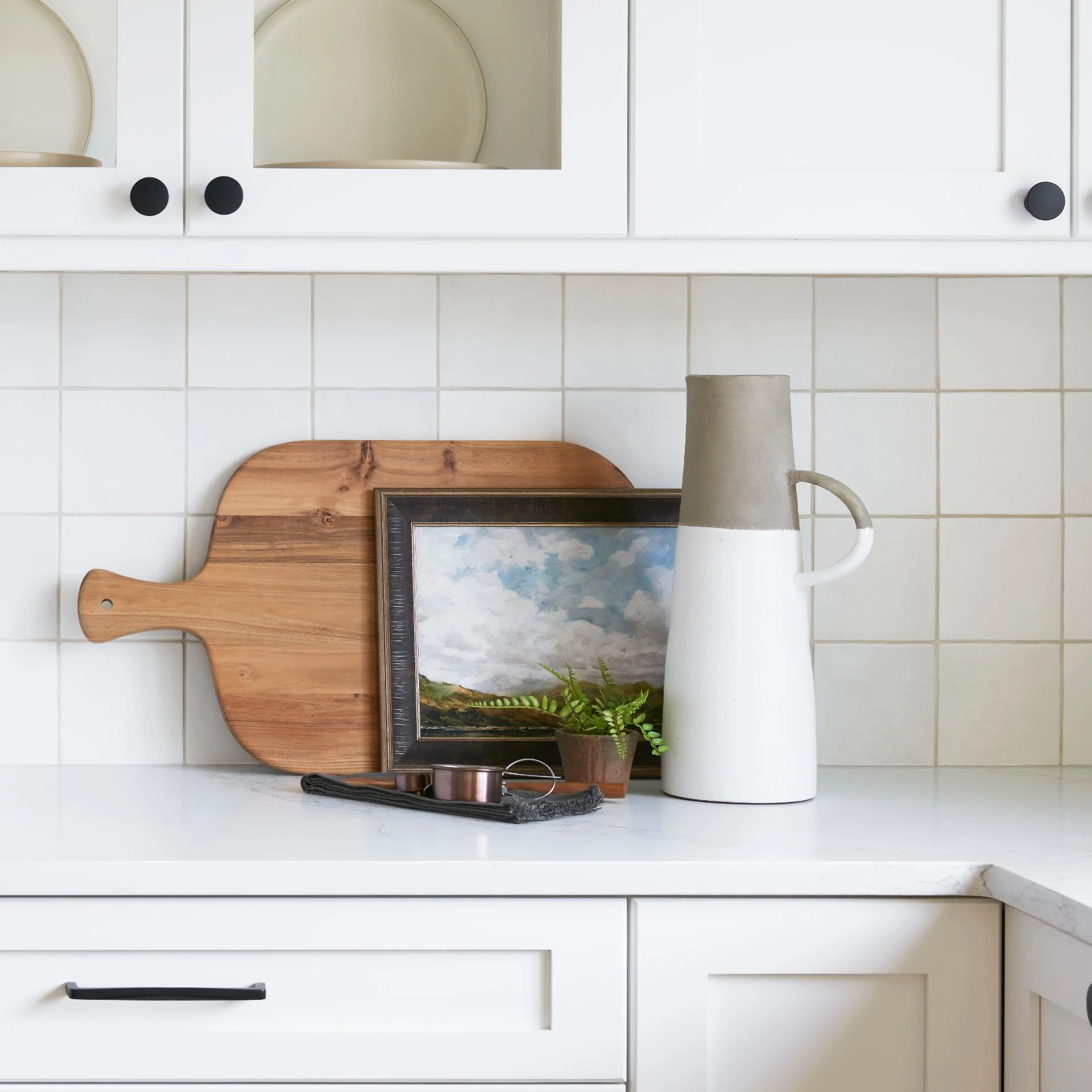 Ceramic jugs and vases styled on shelves in a warm, modern interior