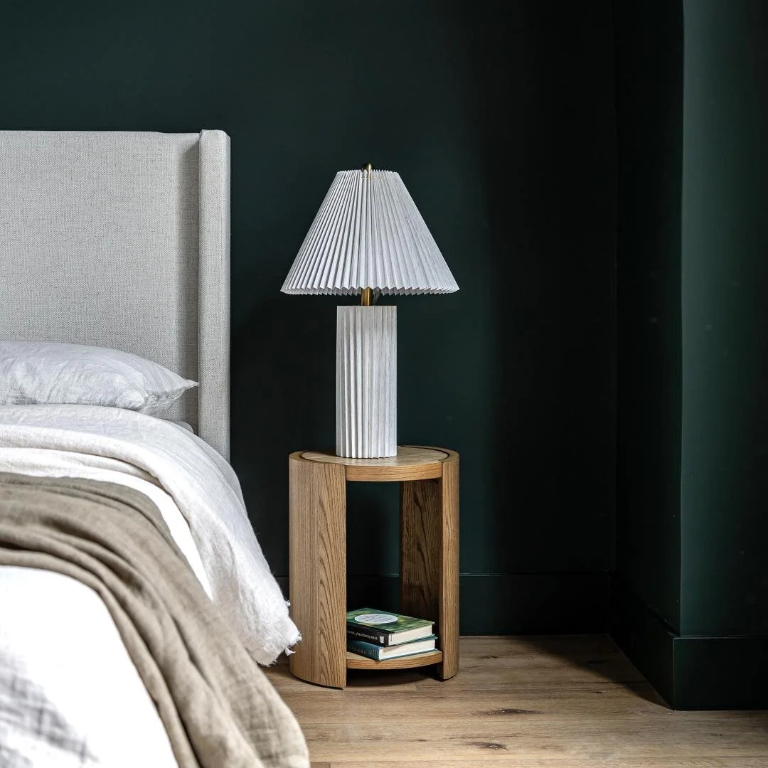 Modern oak side table used next to an accent chair in a West Coast inspired bedroom