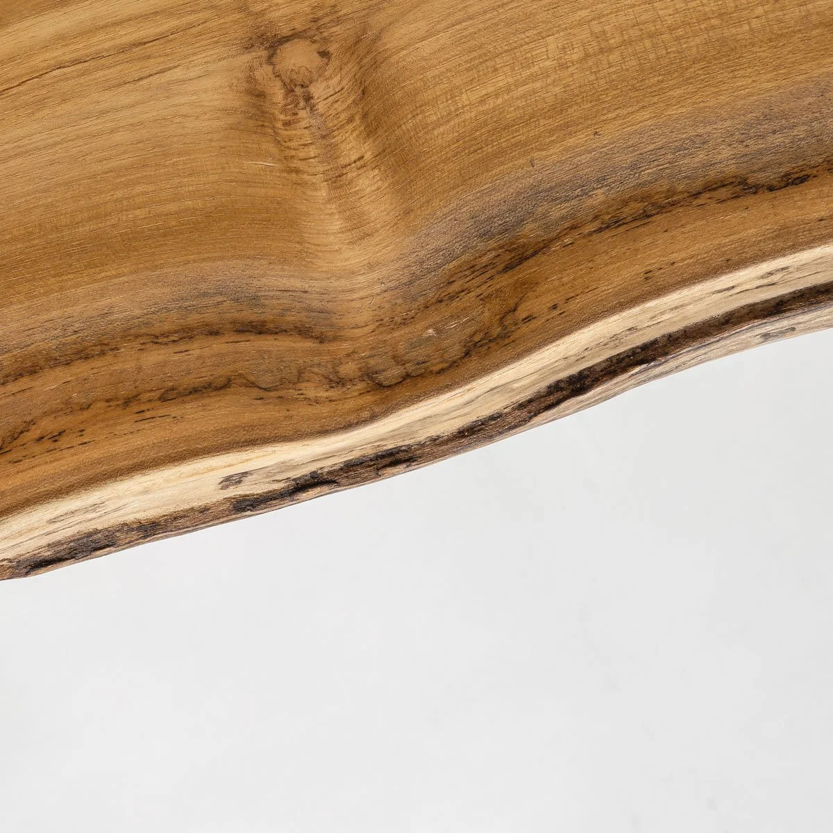 One-of-a-kind teak bench highlighting organic form and texture.jpg