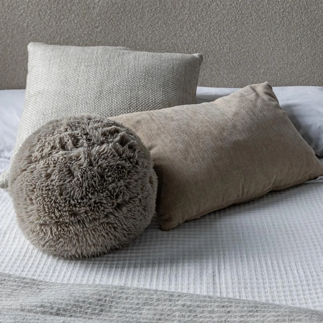 Neutral square throw pillow with soft textured fabric, styled on a sofa in a West Coast minimalist interior.jpg