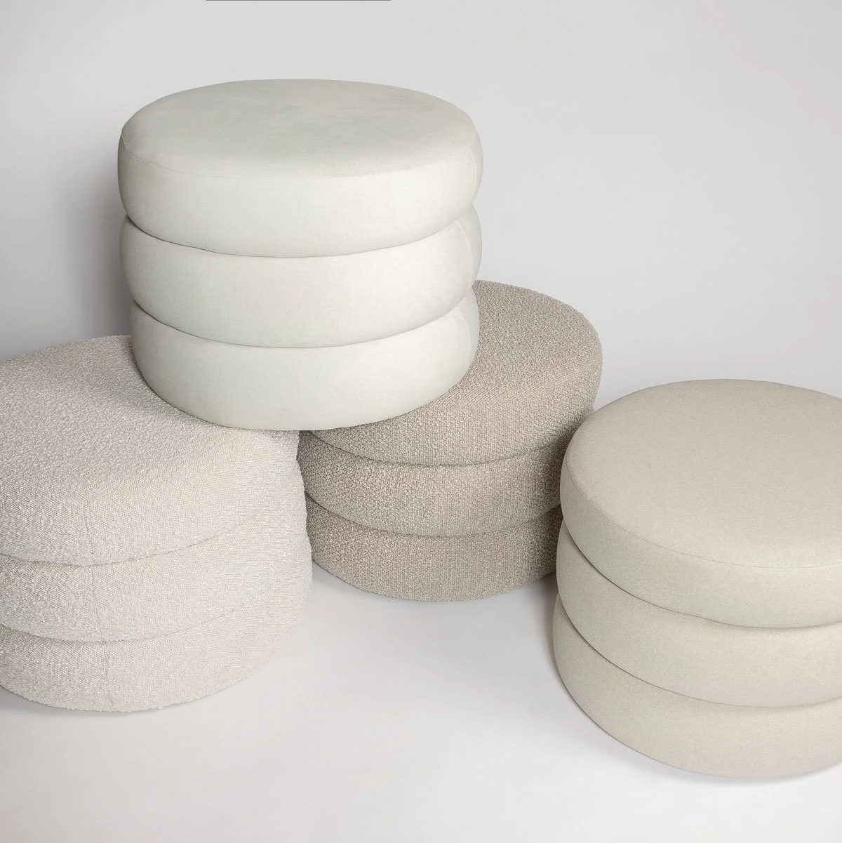 Four neutral poufs styled together as floor cushions for a modern Canadian living space