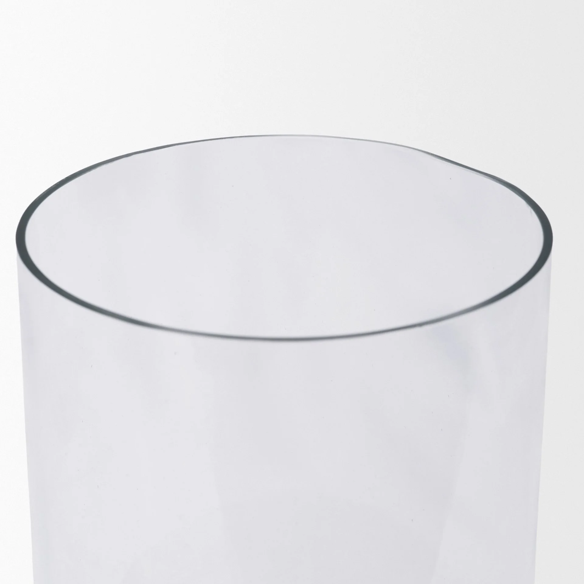 Clear glass cylinder casing designed to protect a pillar candle flame.