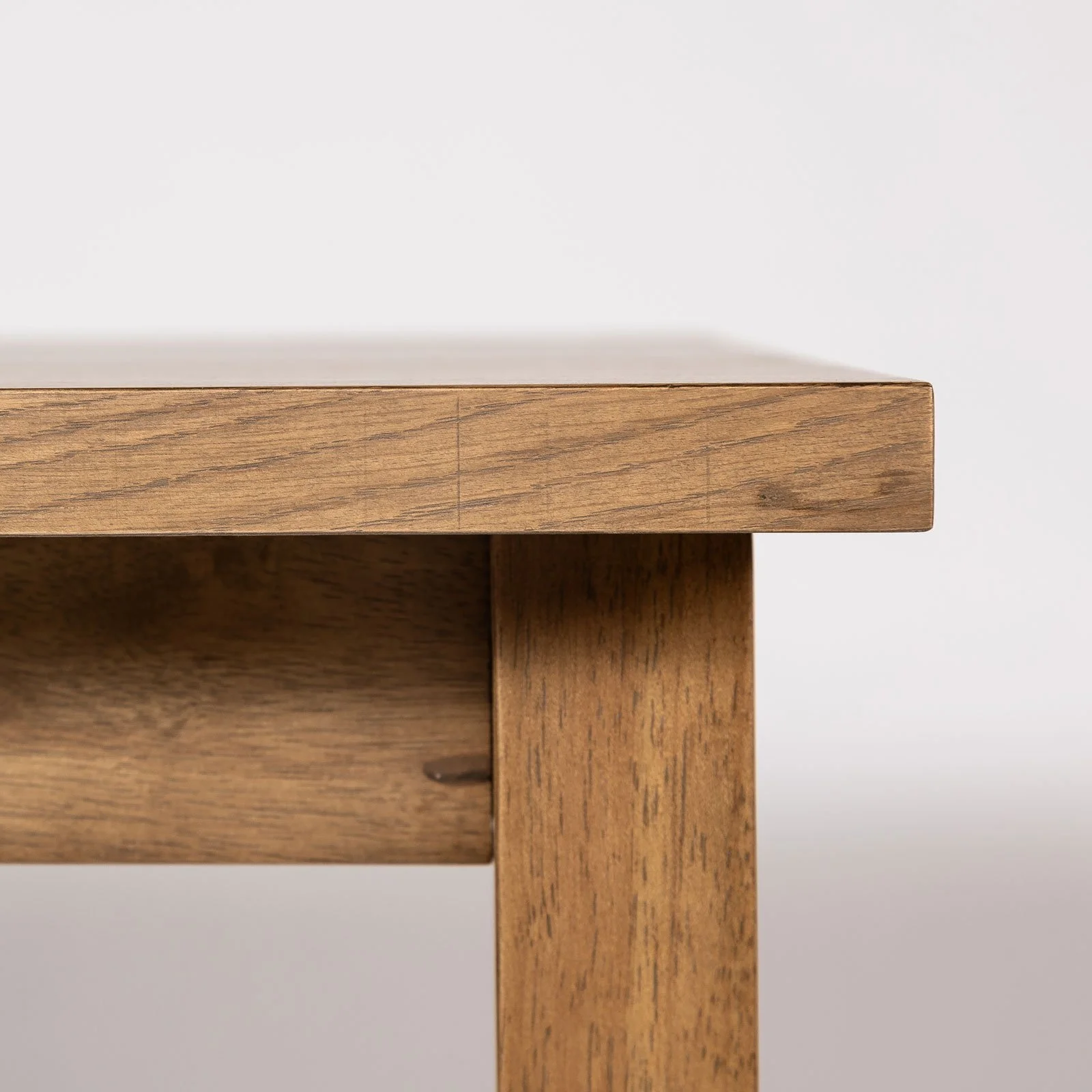 Corner detail of smoked chestnut wood dining table