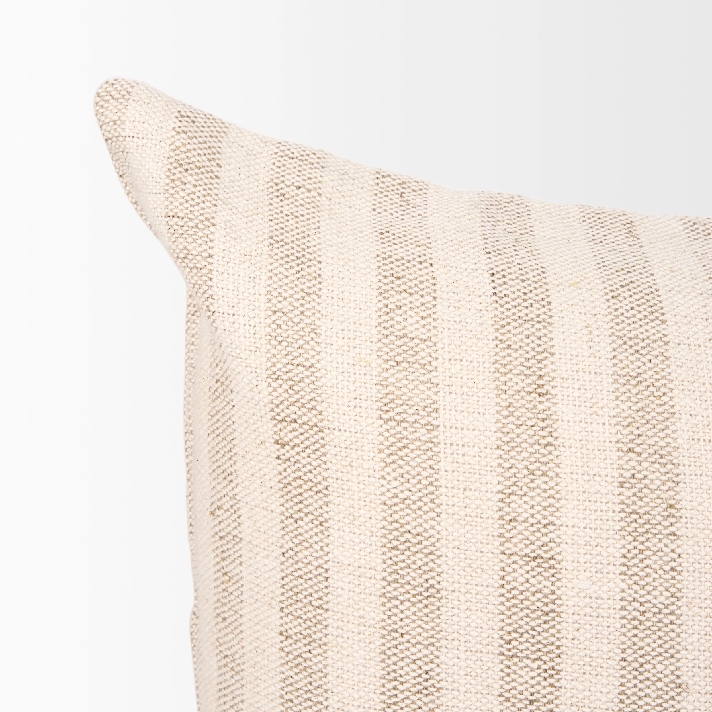 corner detailing on striped linen lumbar pillow.