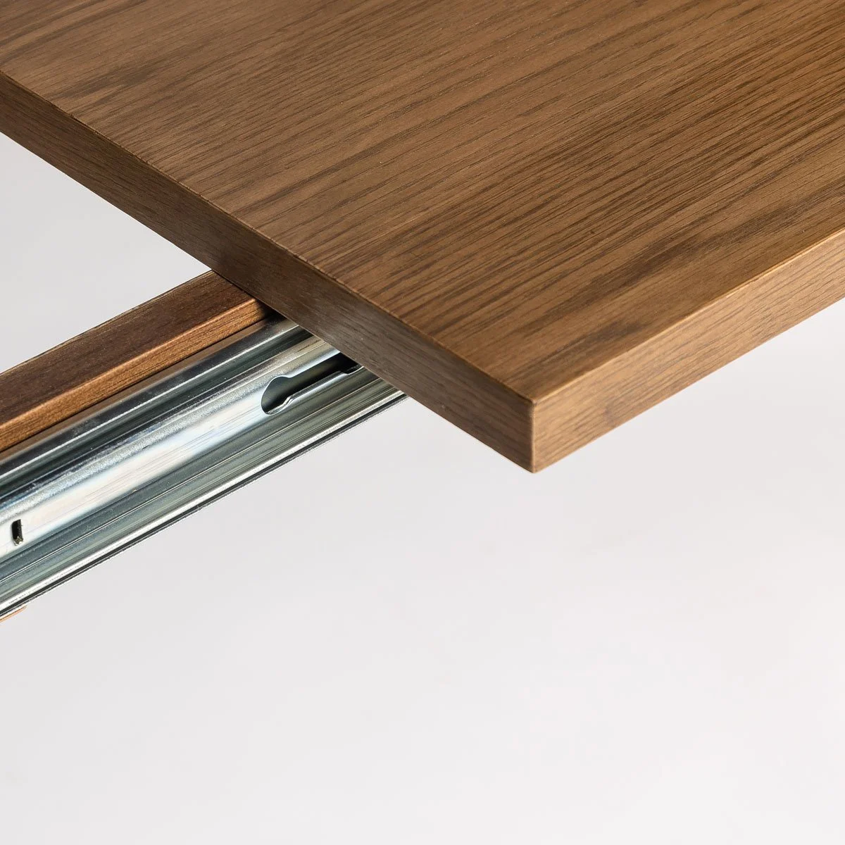 Built-in extension mechanism detail on wood dining table
