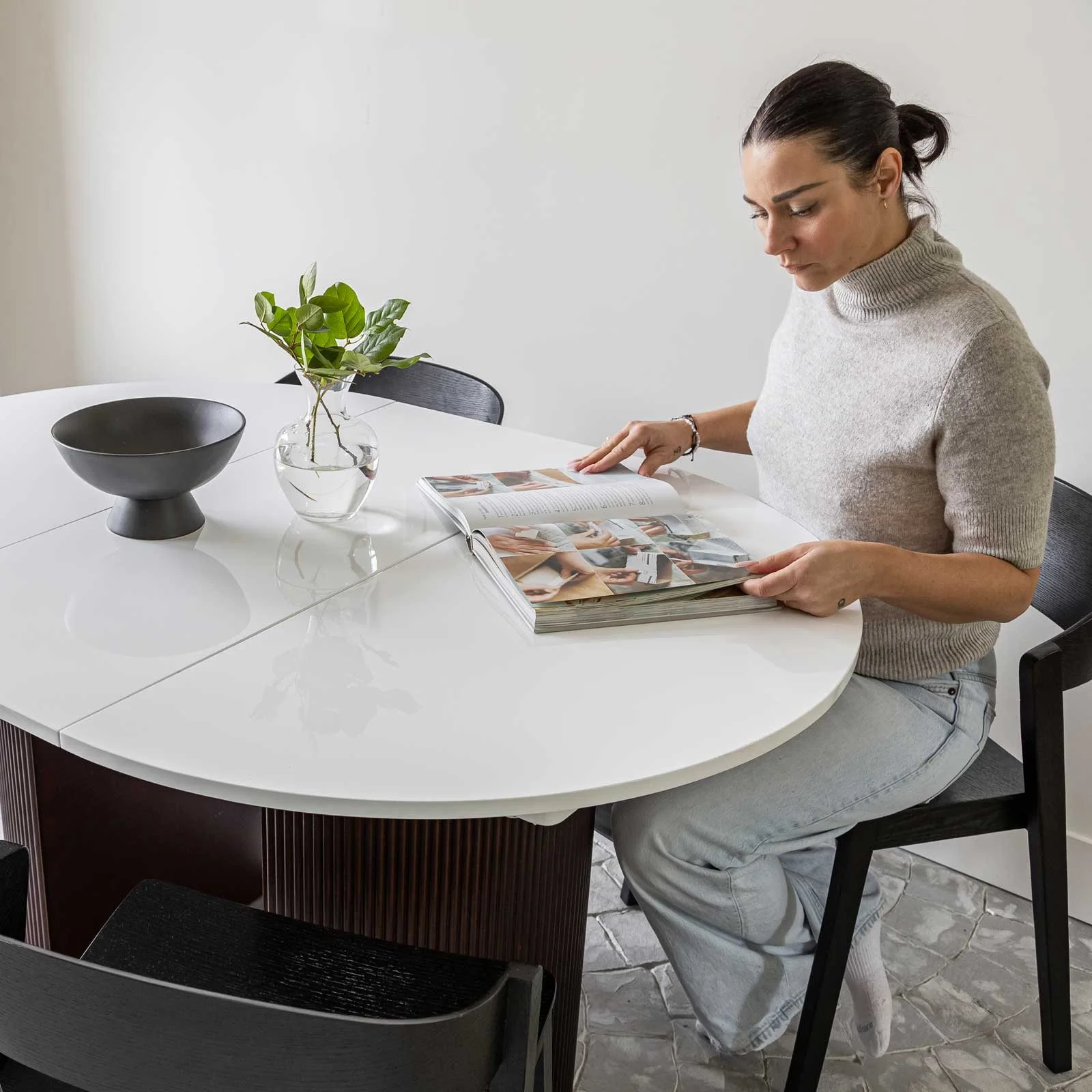 White and brown extension dining table Girl reading book.jpg