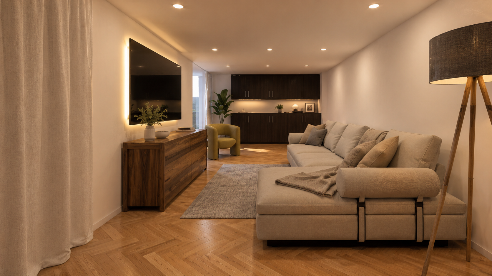 Living room with beige sectional sofa, wooden TV stand with plants, wall-mounted TV, green armchair, large window with curtains, wooden flooring, dark cabinetry, and a black tripod floor lamp.