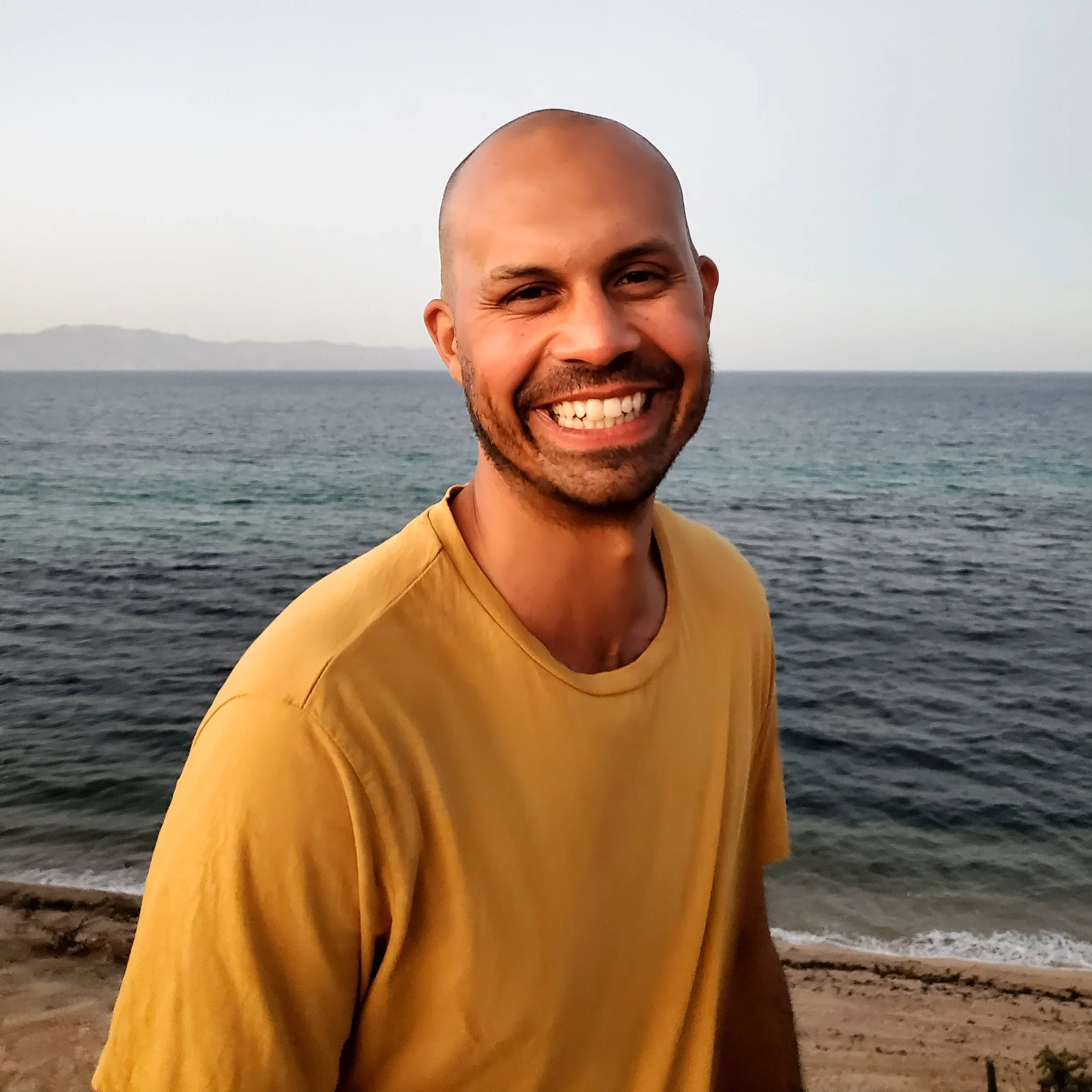Expedition guide Jamie Lally smiling beside a gray whale