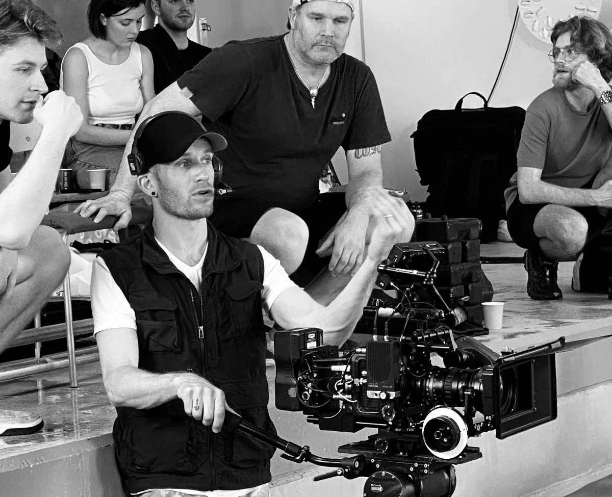 Cinematographer Kjetil Astrup operating a film camera in the water