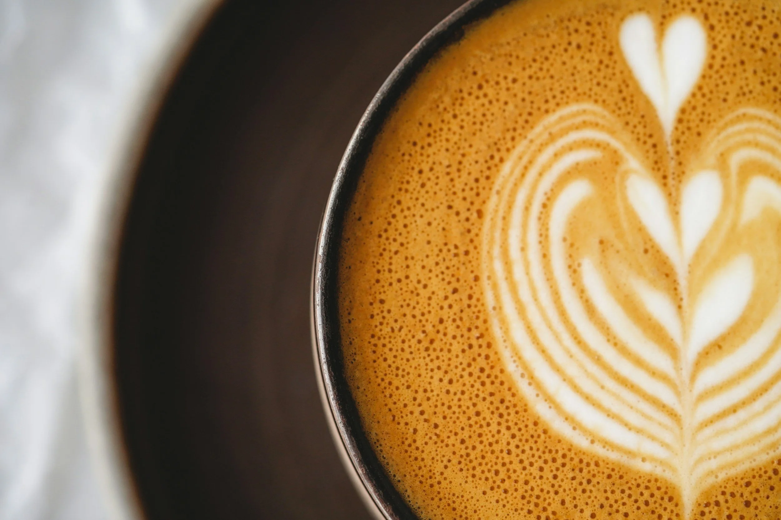 A latte with a heart design taken from above